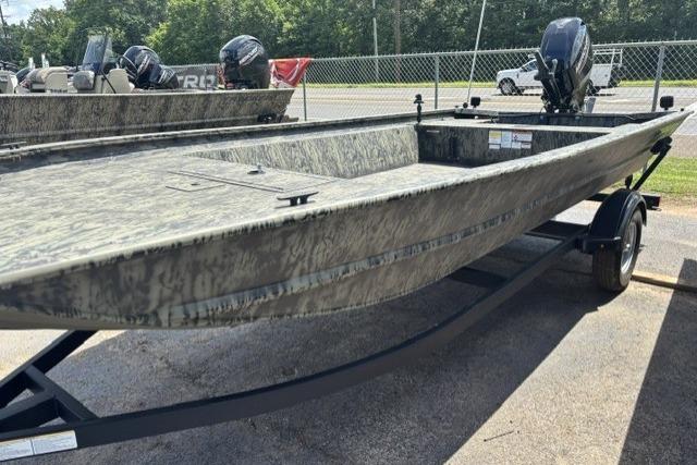 2026 Tracker Grizzly 1860 Utility boat on trailer, camo design, parked outdoors.