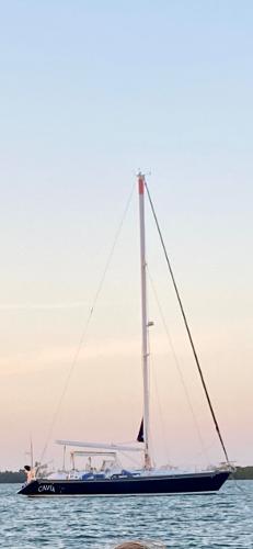 Sailing yacht Concordia 52, 1989 model, anchored on calm waters at sunset.