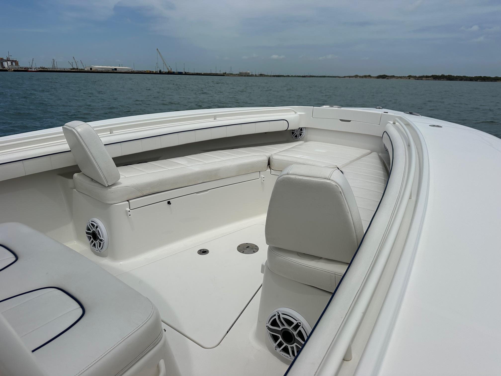 2016 Regulator center console boat with white seating and ocean backdrop.