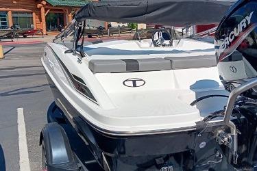 2026 Tahoe T16 boat with Mercury engine, parked outdoors.