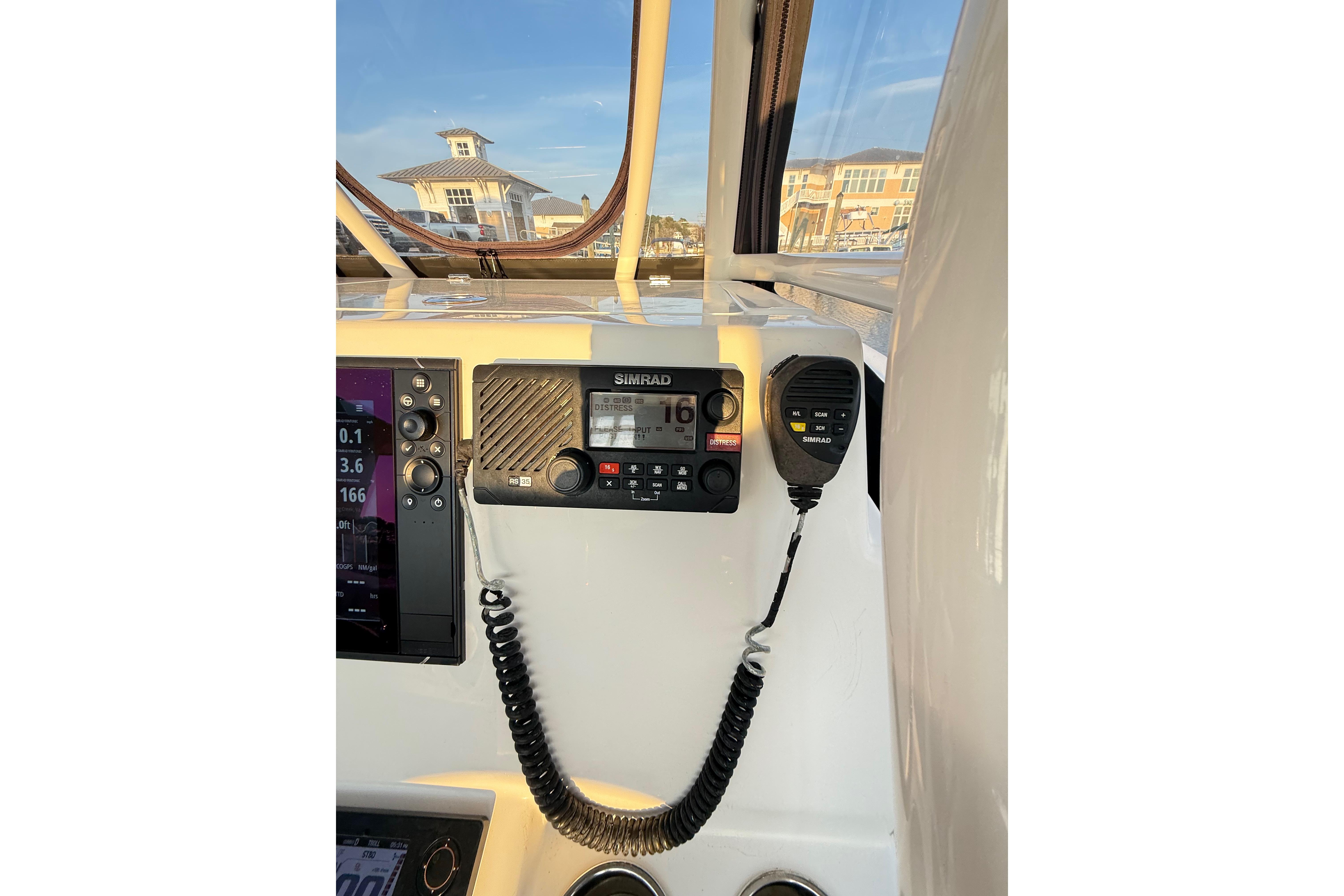 2016 Cobia 296 Center Console boat dashboard with Simrad marine radio.