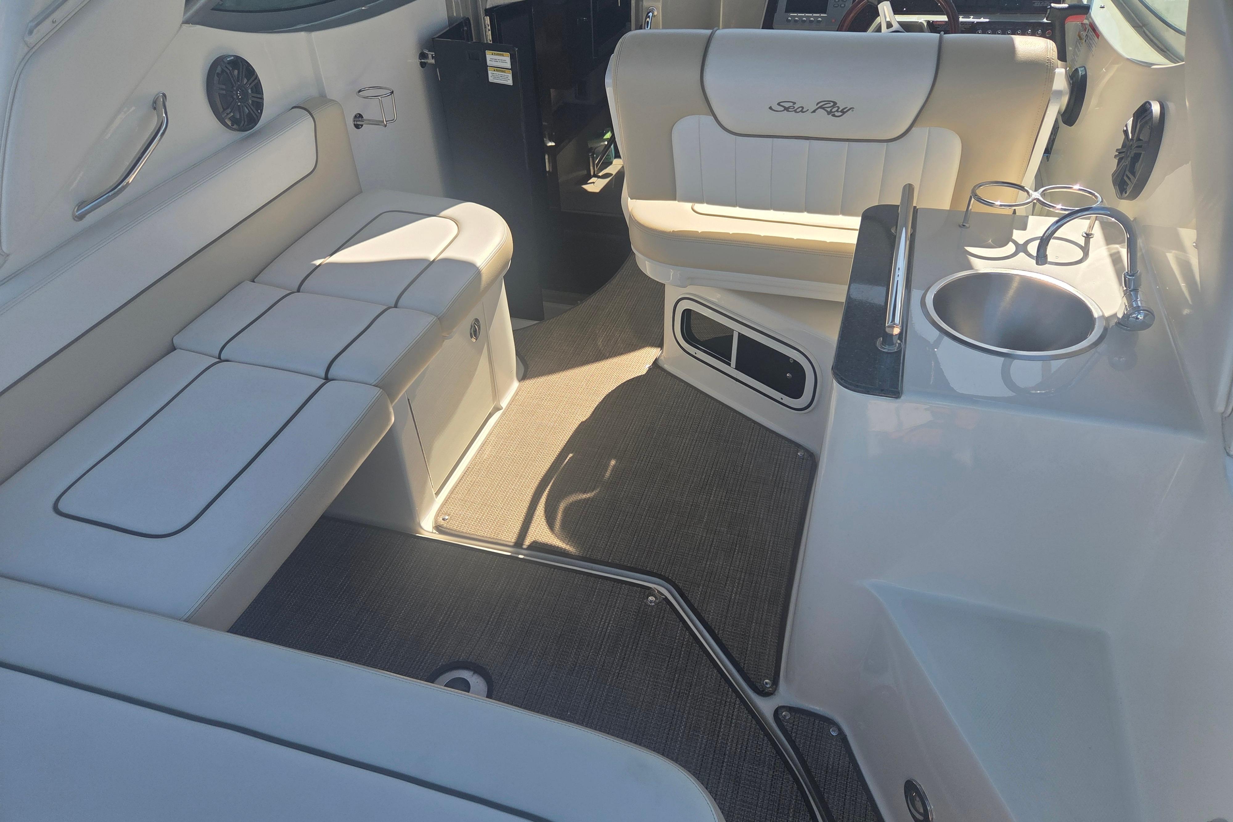 Interior of 2012 Sea Ray Sundancer 260 boat with seating and sink area.