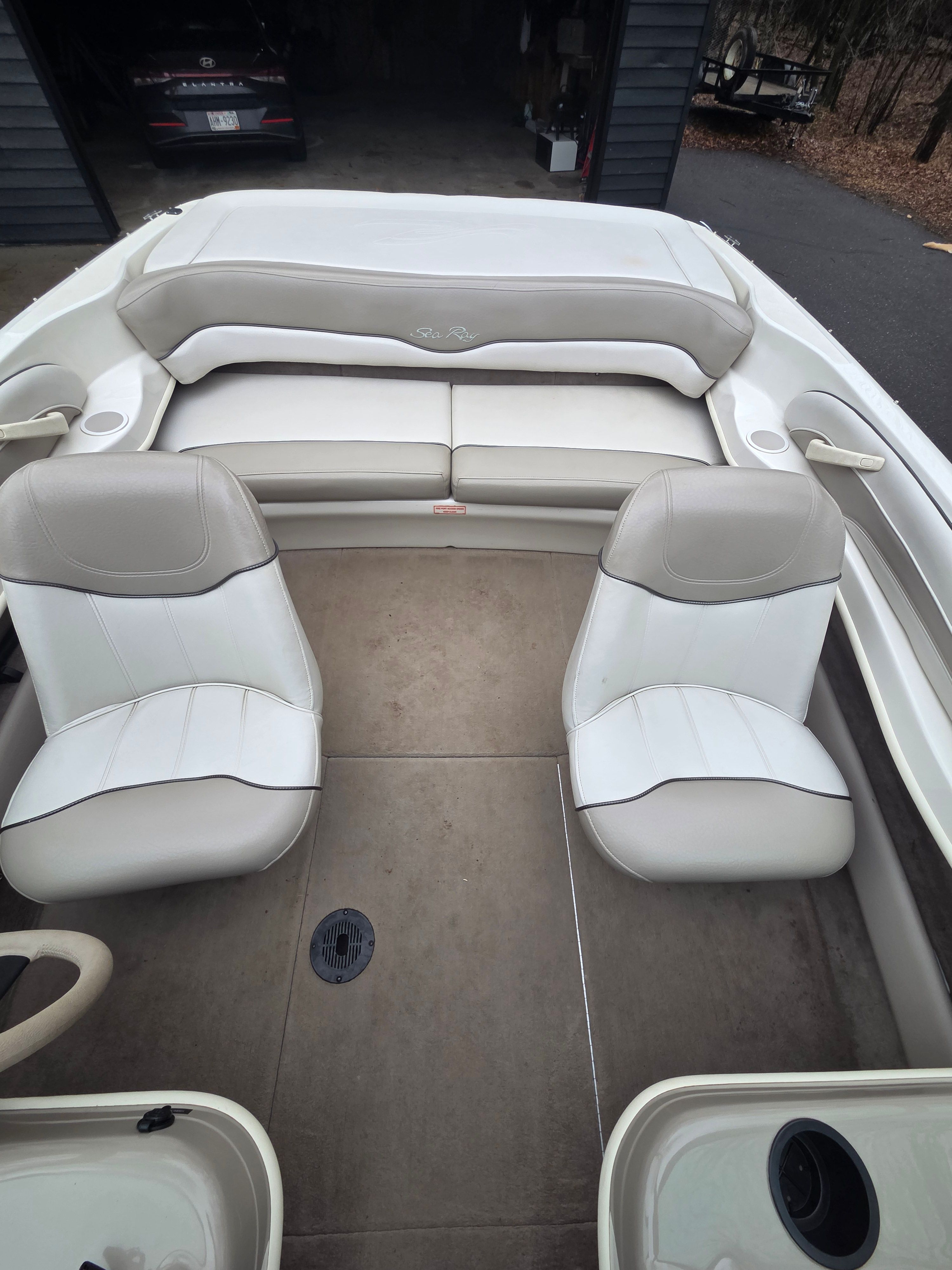 Interior of a 2002 Sea Ray 182 boat with beige seating.