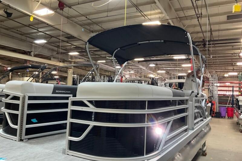 2026 Bennington 22 SSRSF pontoon boat in a factory setting, showcasing sleek design.
