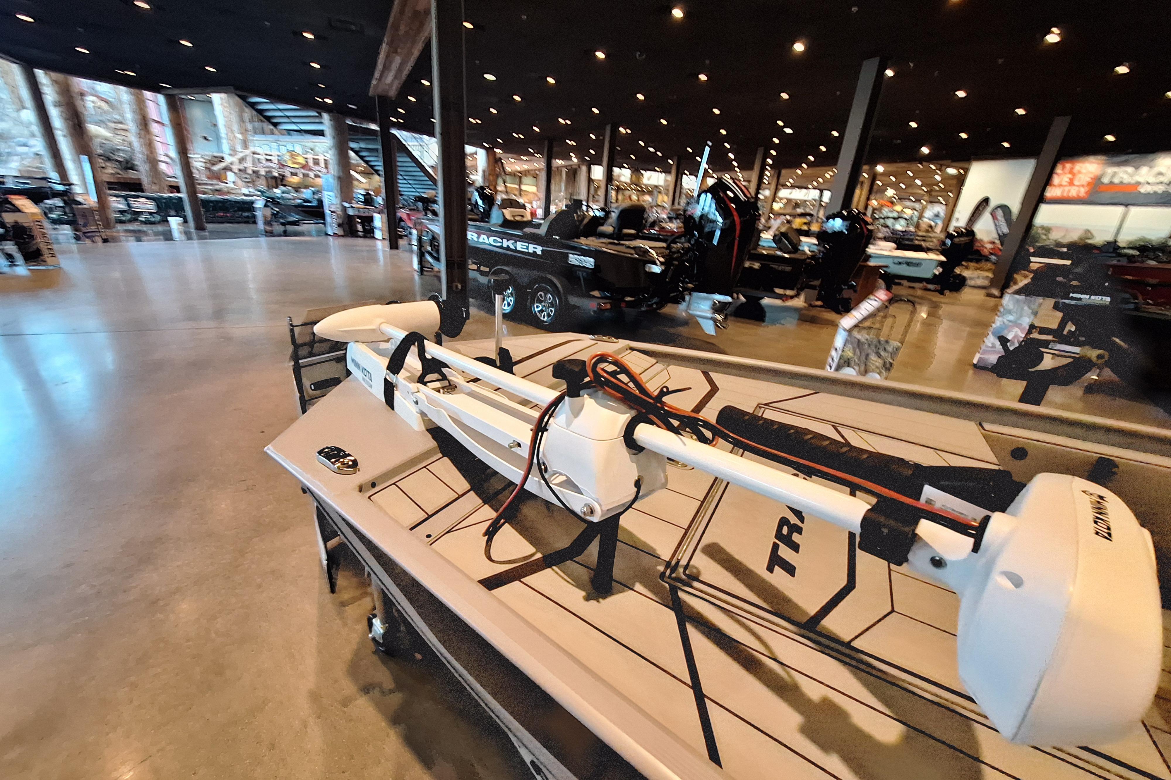 2026 Tracker Bass Tracker Classic CC boat displayed in a showroom with modern lighting.