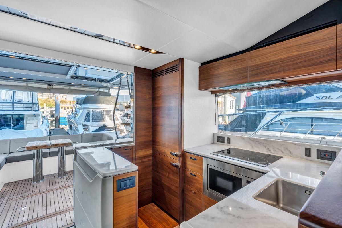 Luxurious 2018 Princess S60 yacht interior with modern kitchen and marina view.