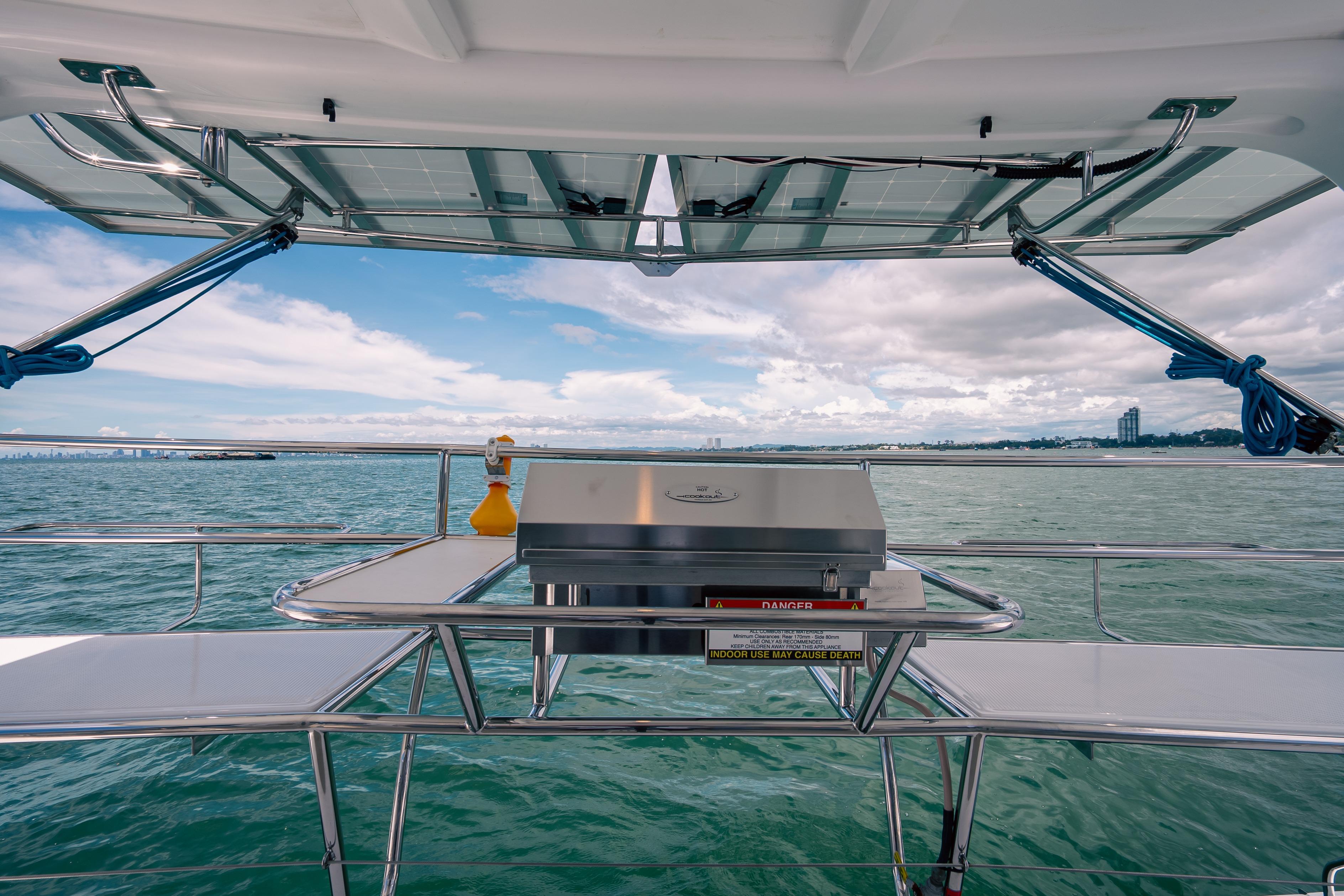 2026 Seawind 1160XL yacht with outdoor grill, ocean view, and solar panels.
