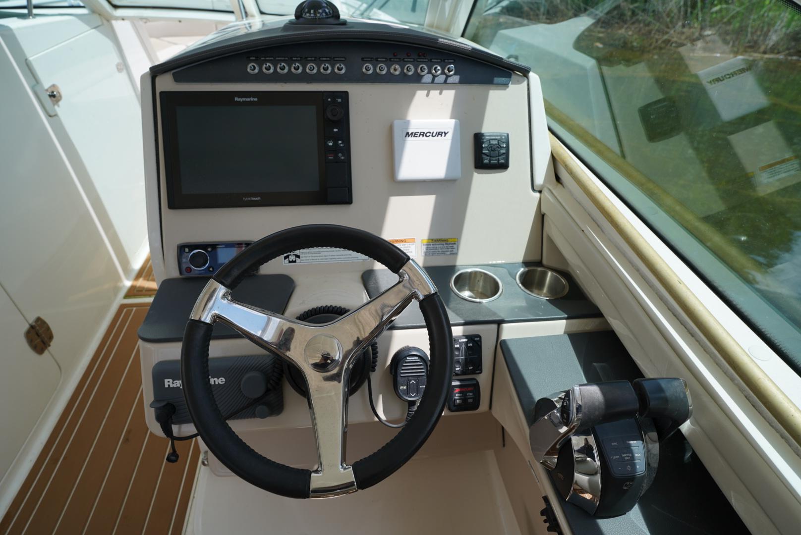 2016 Boston Whaler 320 Vantage helm with steering wheel, navigation system, and controls.