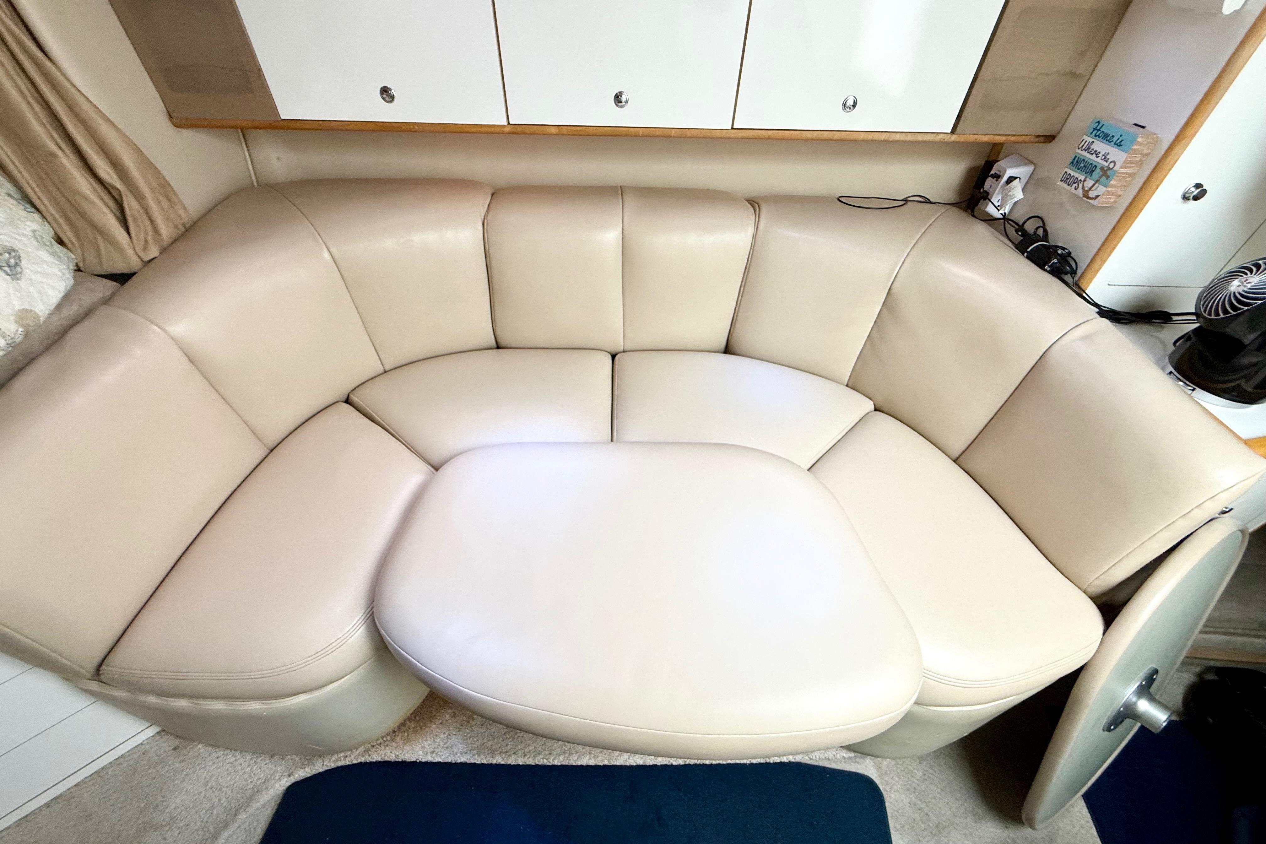 1999 Chaparral Signature 300 interior with beige leather seating and modern cabinetry.