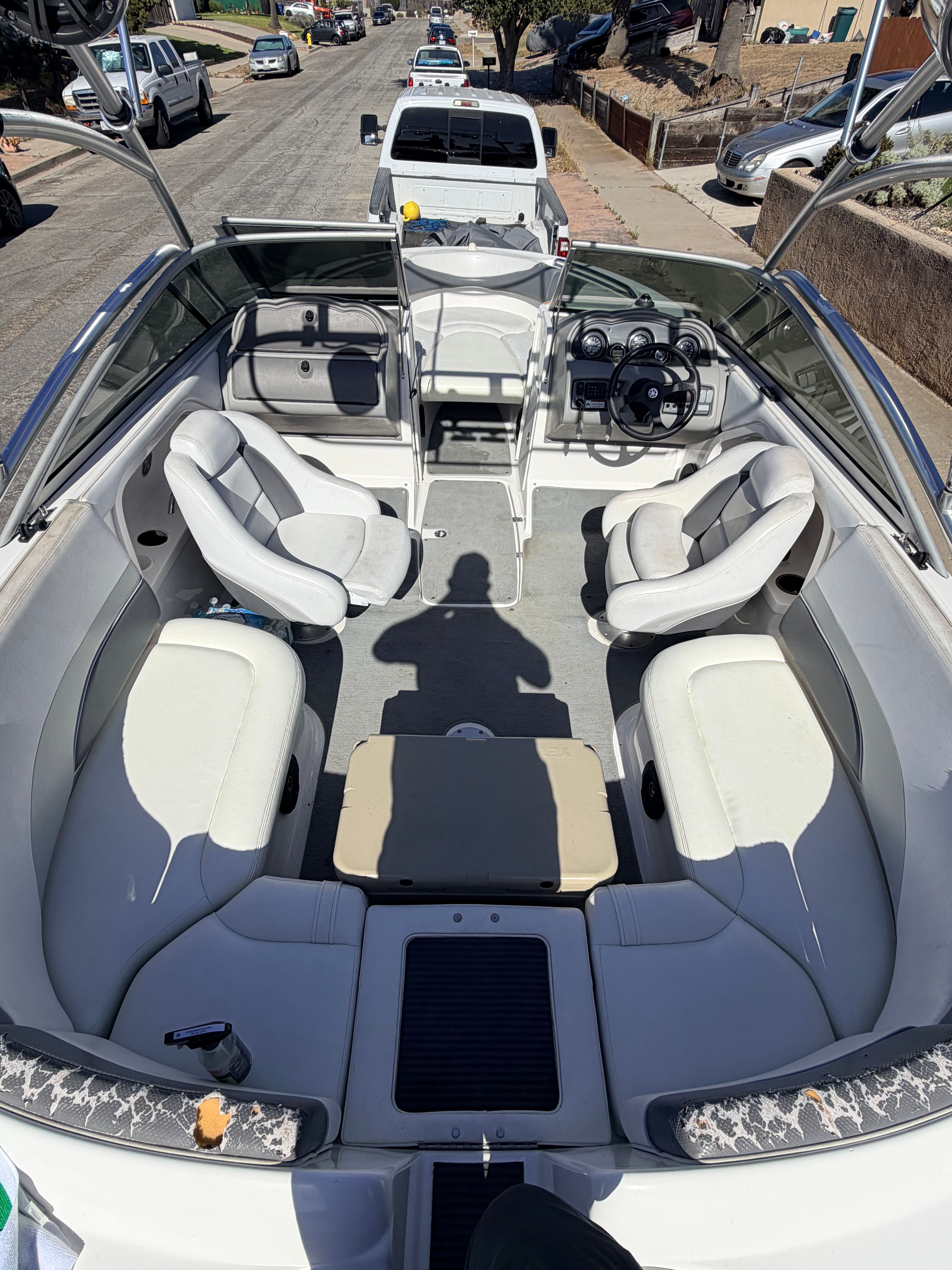 Interior view of a 2005 Yamaha AR230 boat with white seating and gray flooring.