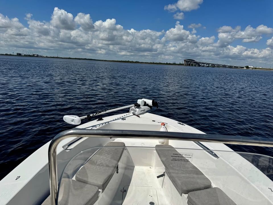 Sea Pro 199 Center Console 2022 on calm water under blue sky.