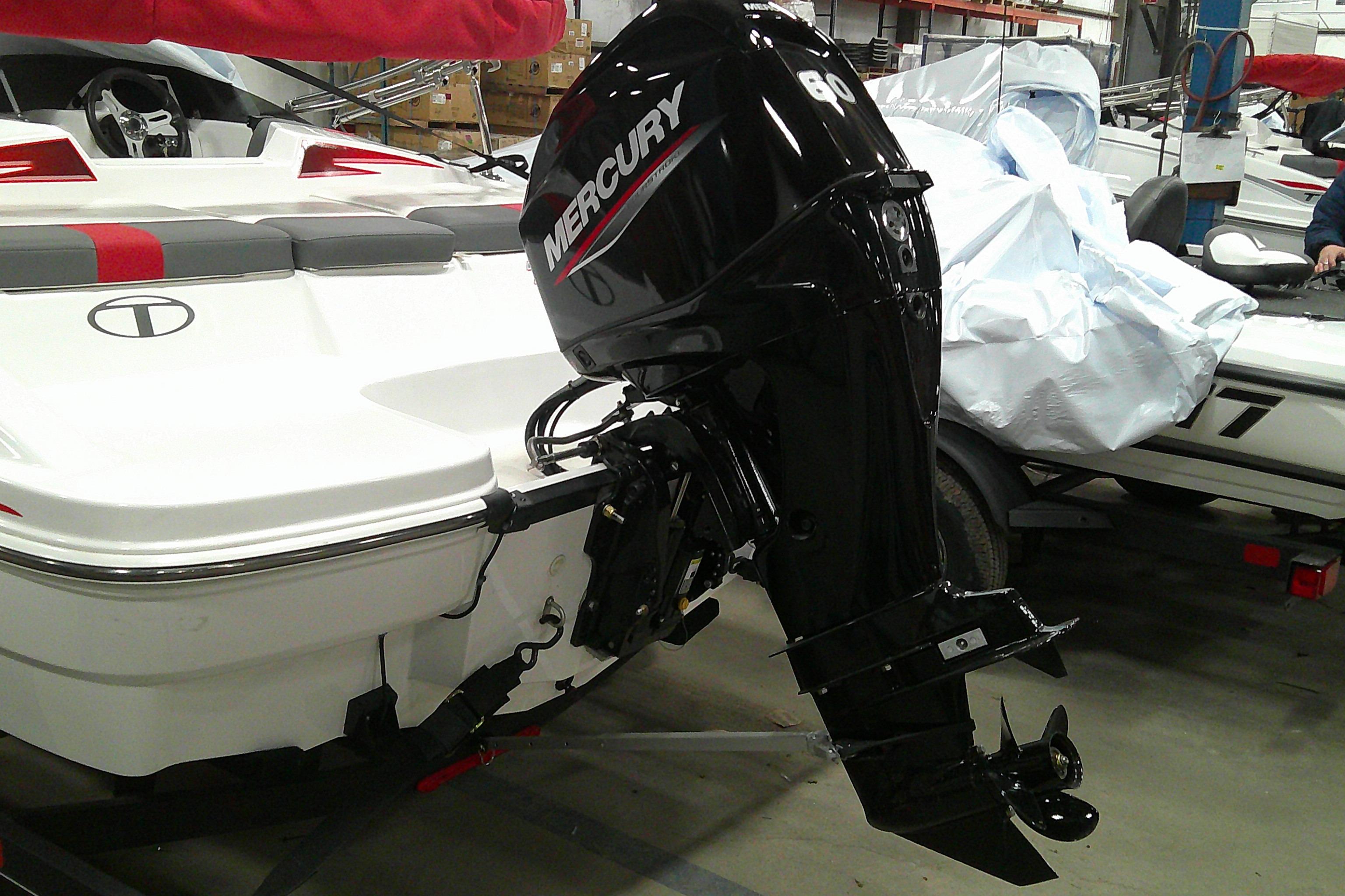 2024 Tahoe T16 boat with Mercury outboard motor in a showroom.