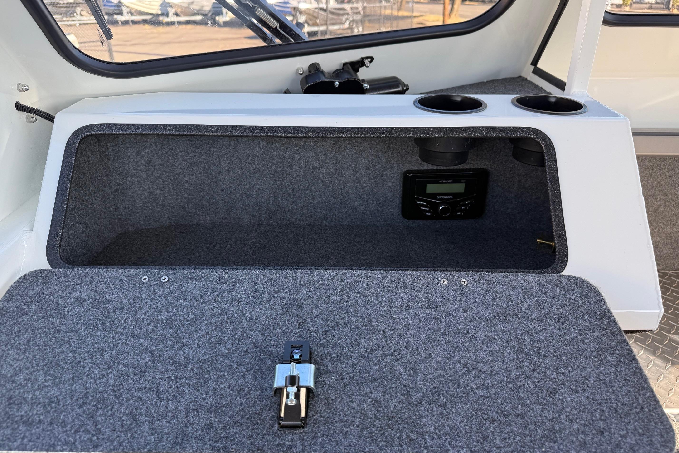 Interior of 2026 Thunder Jet 185 Luxor boat with storage compartment and audio system.