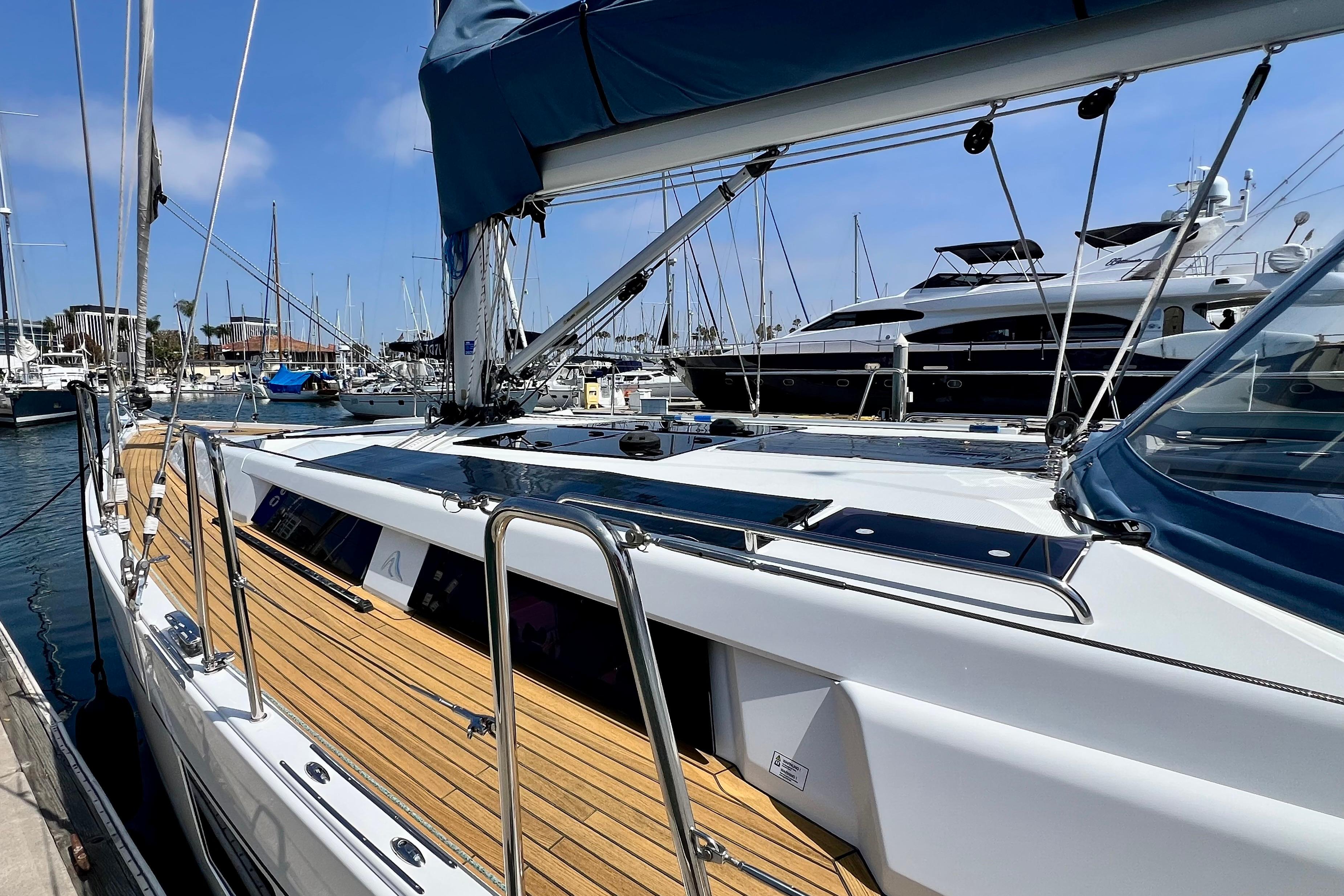 2016 Hanse 455 yacht docked in marina, featuring sleek design and wooden deck.