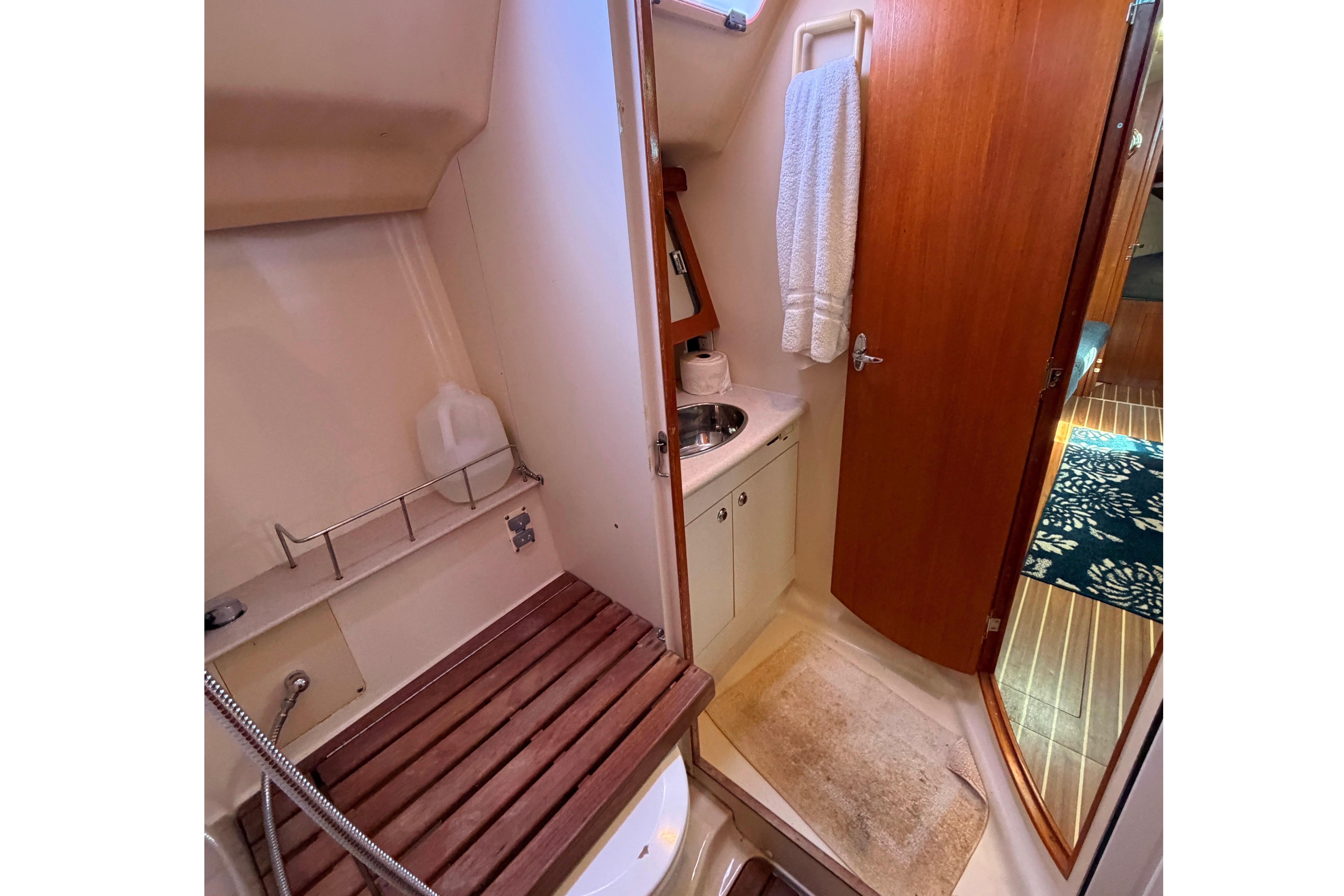 2005 Hunter 38 yacht bathroom with wooden accents and compact sink area.
