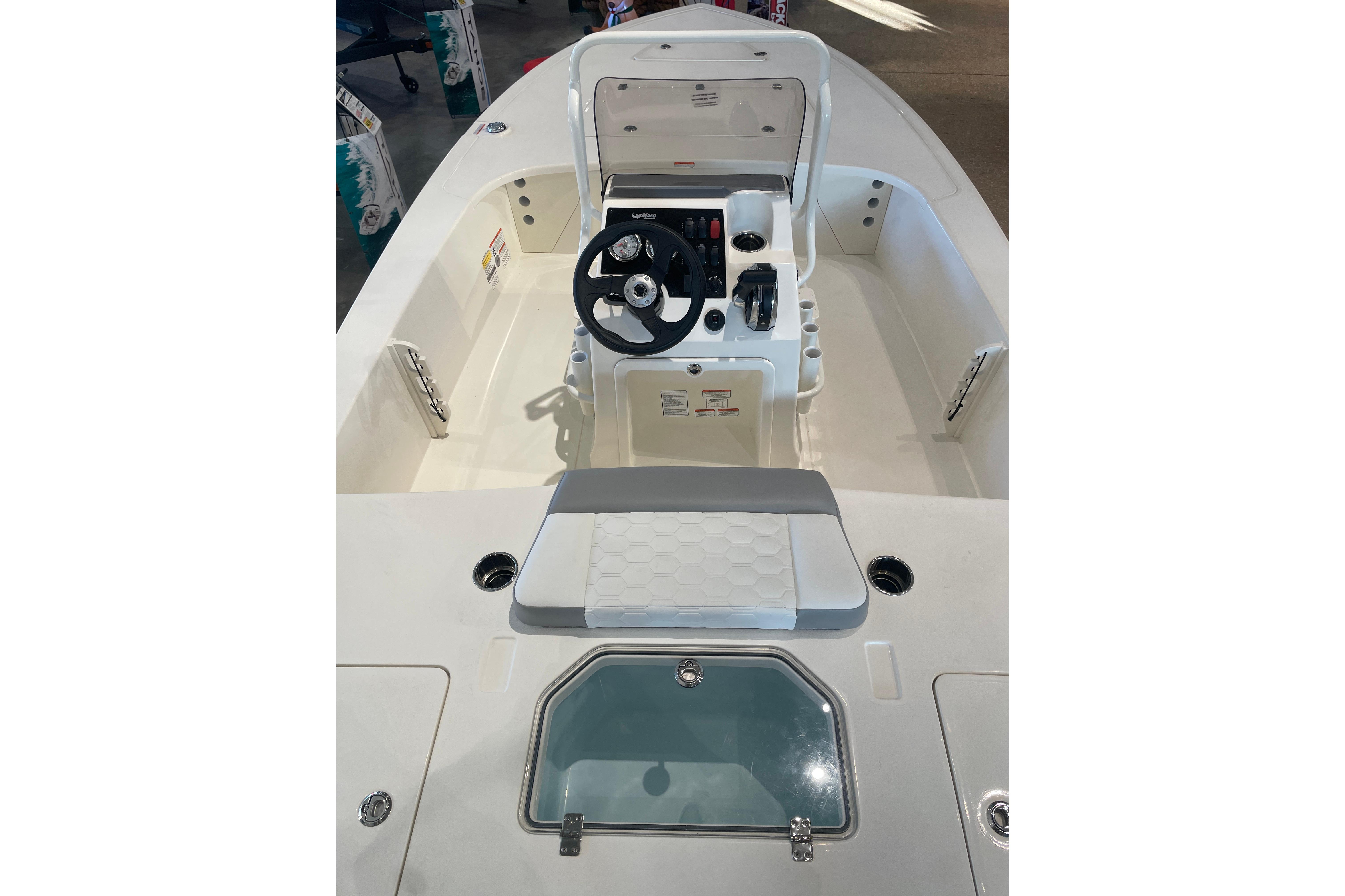 2026 Mako 18 Pro Skiff boat interior with steering console and seating.