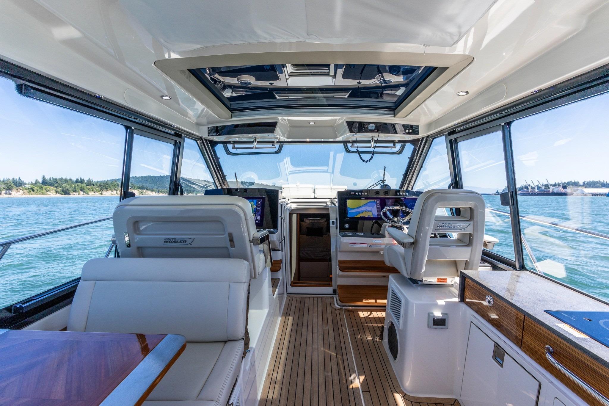 Interior of 2023 Boston Whaler 405 Conquest yacht, featuring luxurious seating and advanced navigation systems.