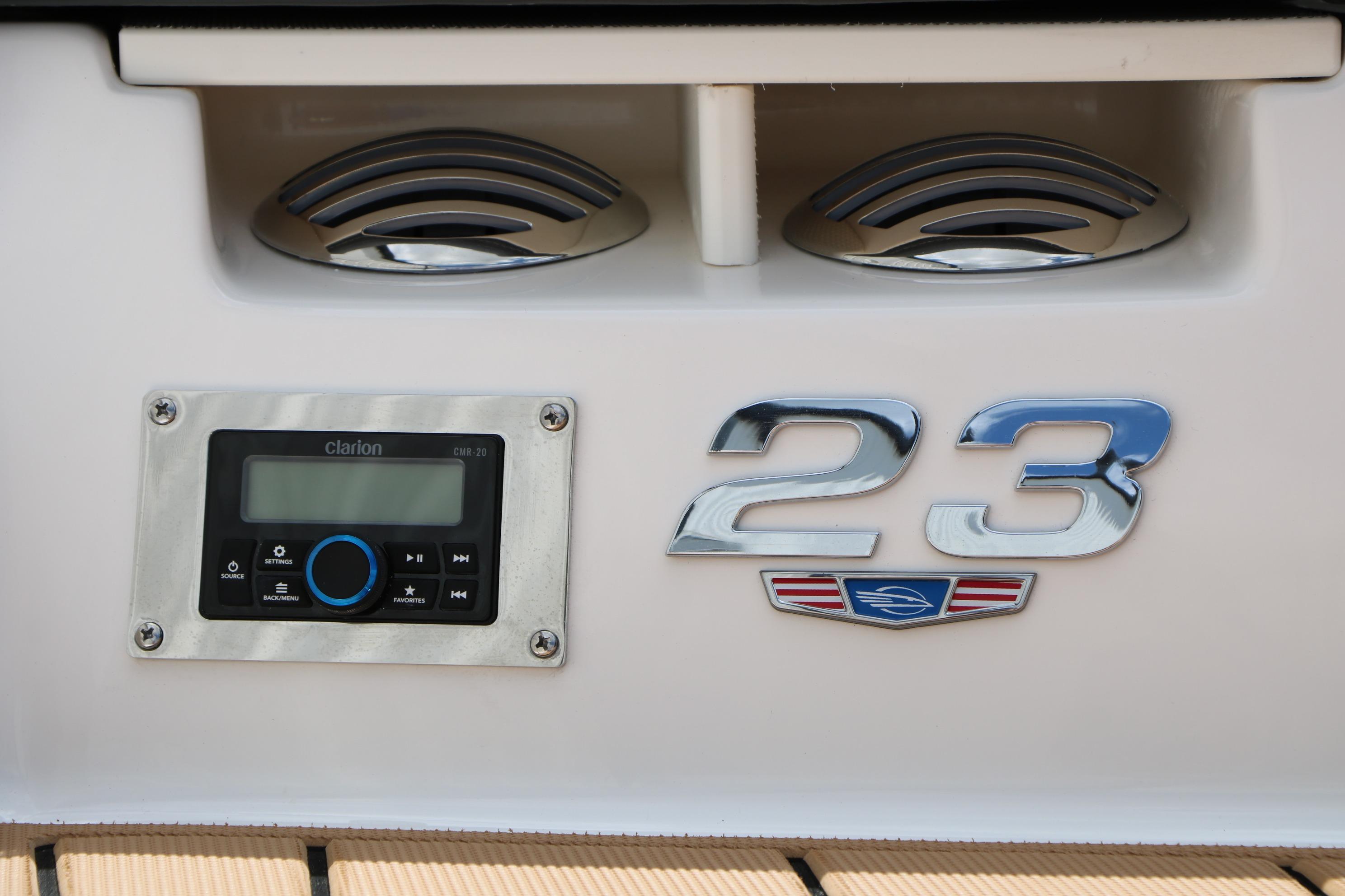 2025 Chaparral 23 SSi boat dashboard with Clarion audio system and chrome detailing.