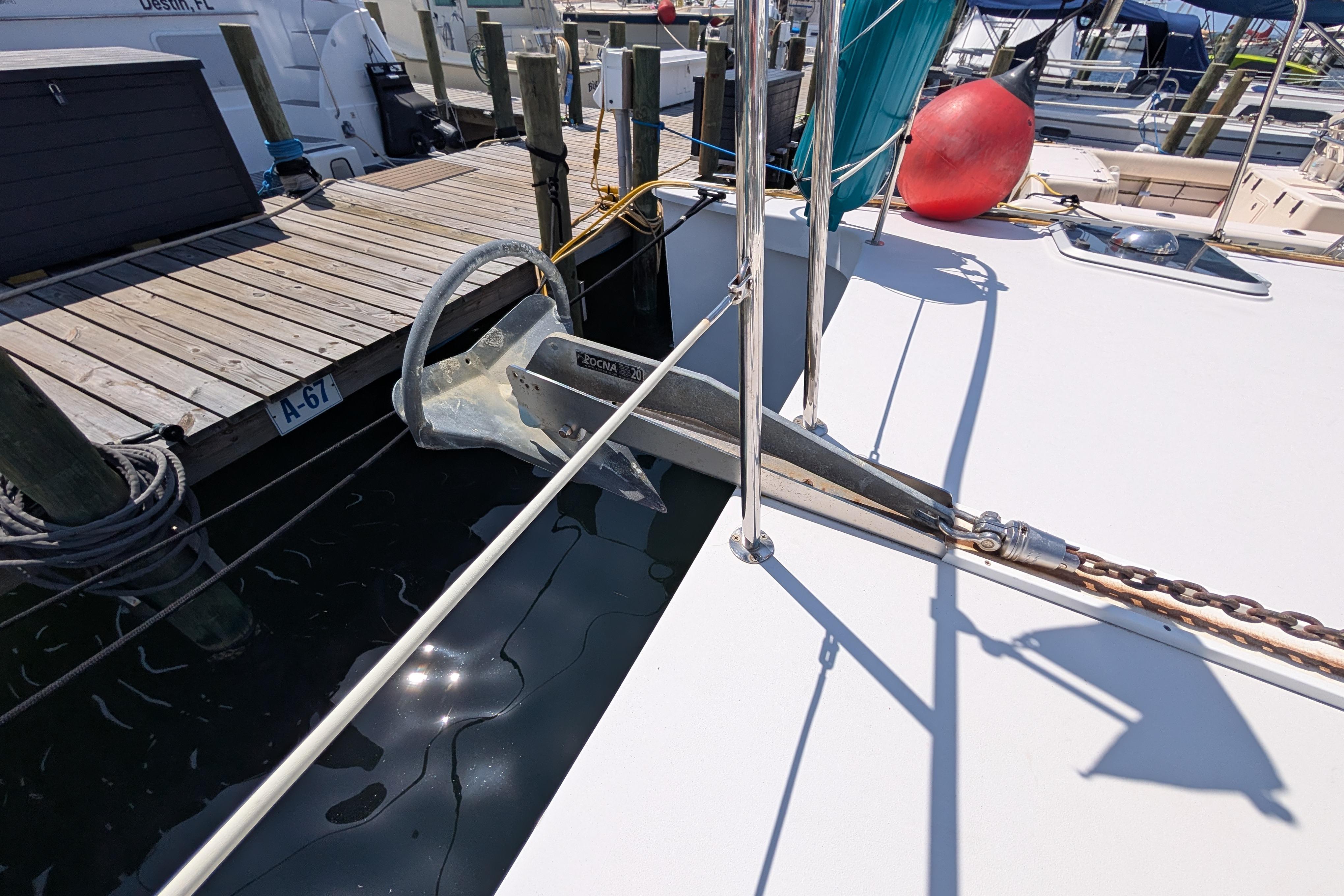 Bow of 2004 PDQ 34 Powercat with Rocna anchor at marina dock.