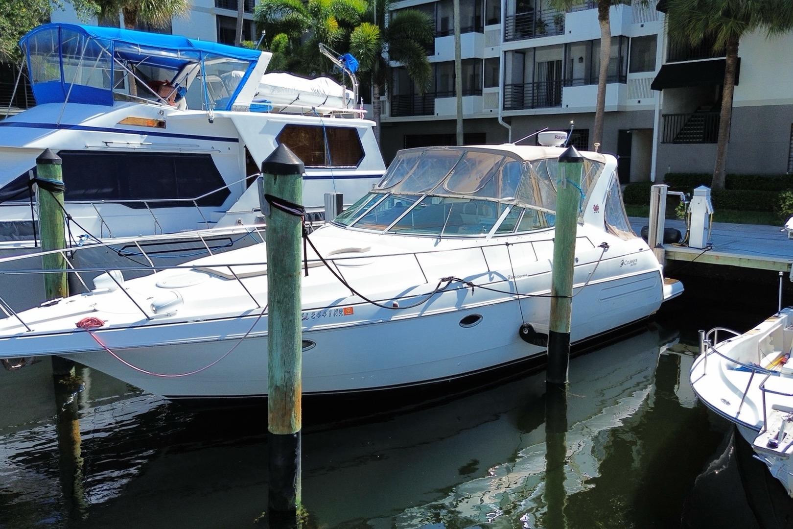 2002 Cruisers Yachts 3572 Express docked at marina, surrounded by other boats.
