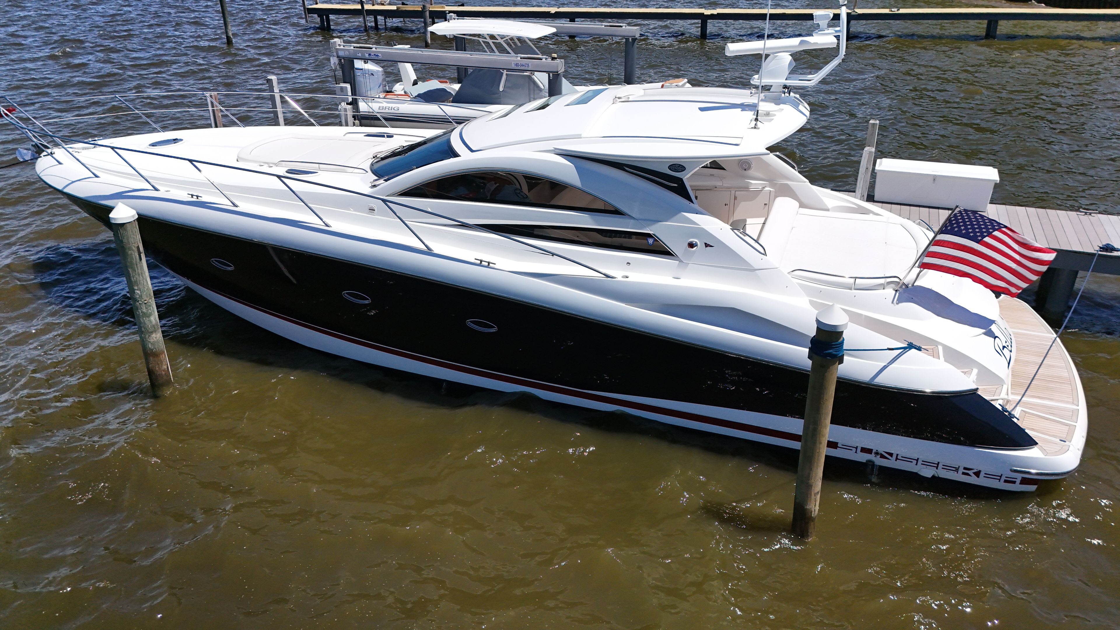 2008 Sunseeker Portofino 53 docked with an American flag displayed.
