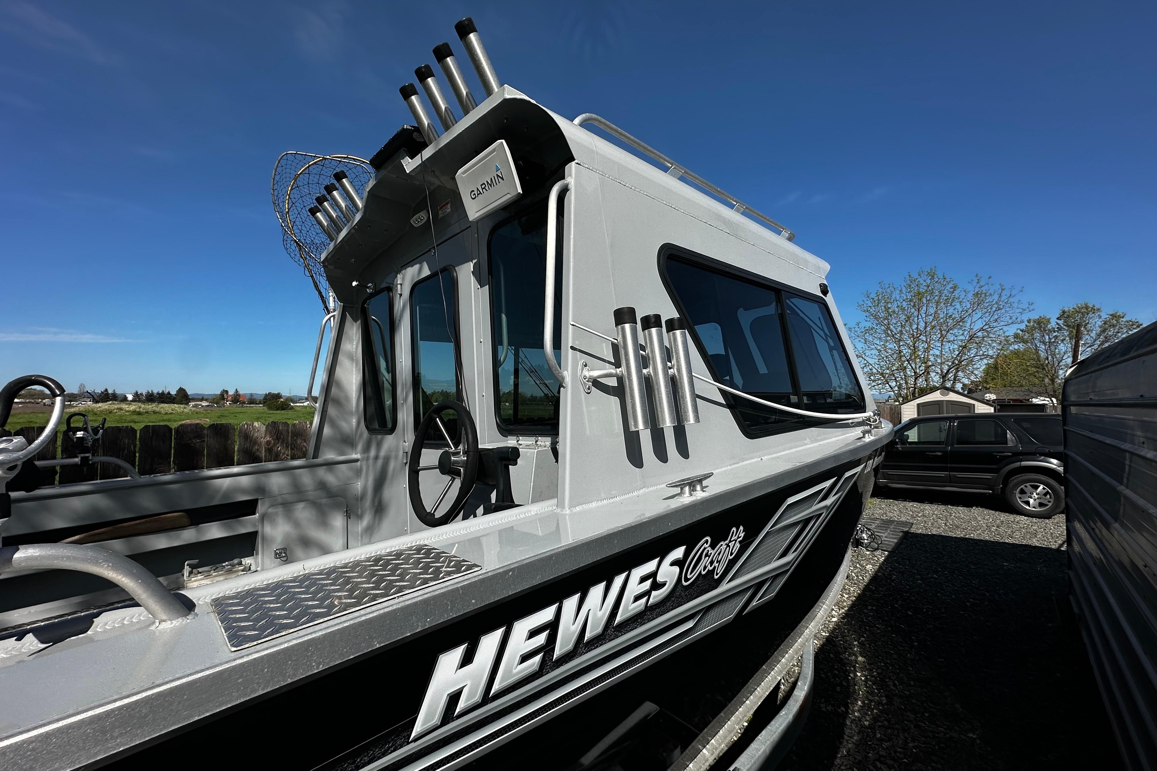 2022 Hewescraft 220 Ocean Pro ET Hardtop boat with hardtop and fishing rod holders.