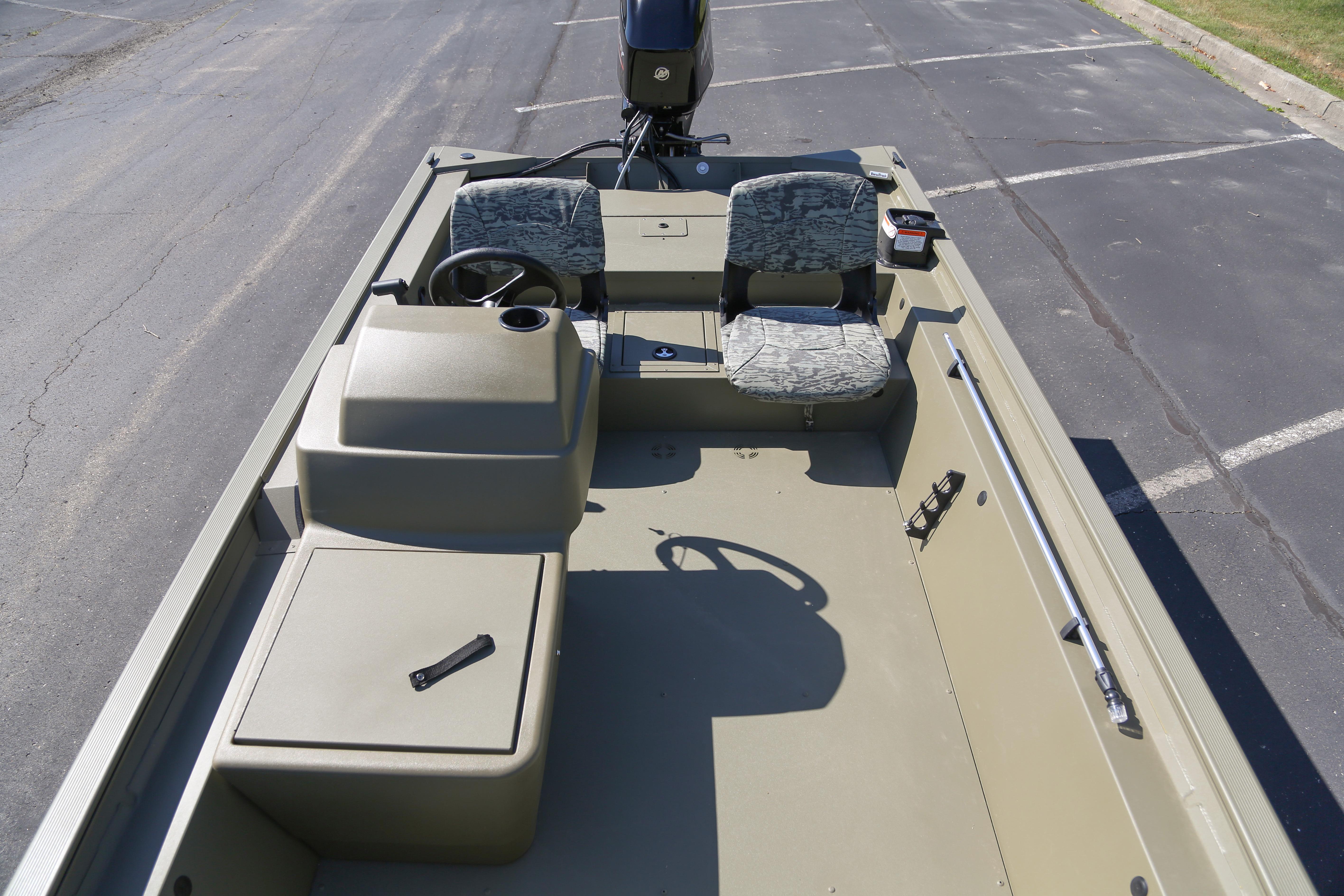 2026 Tracker Grizzly 1754 SC boat interior with steering console and seating.
