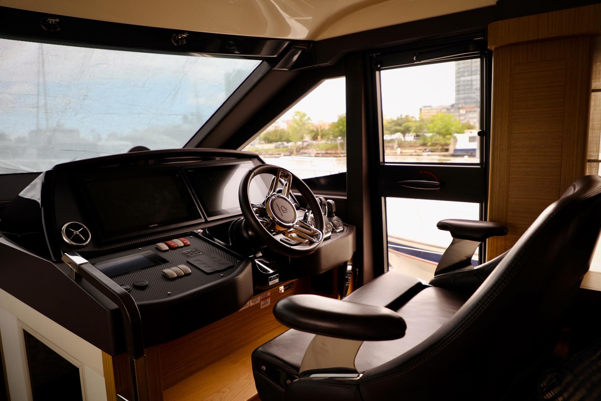 Interior cockpit of 2019 Absolute 50 Fly yacht, featuring modern steering and controls.