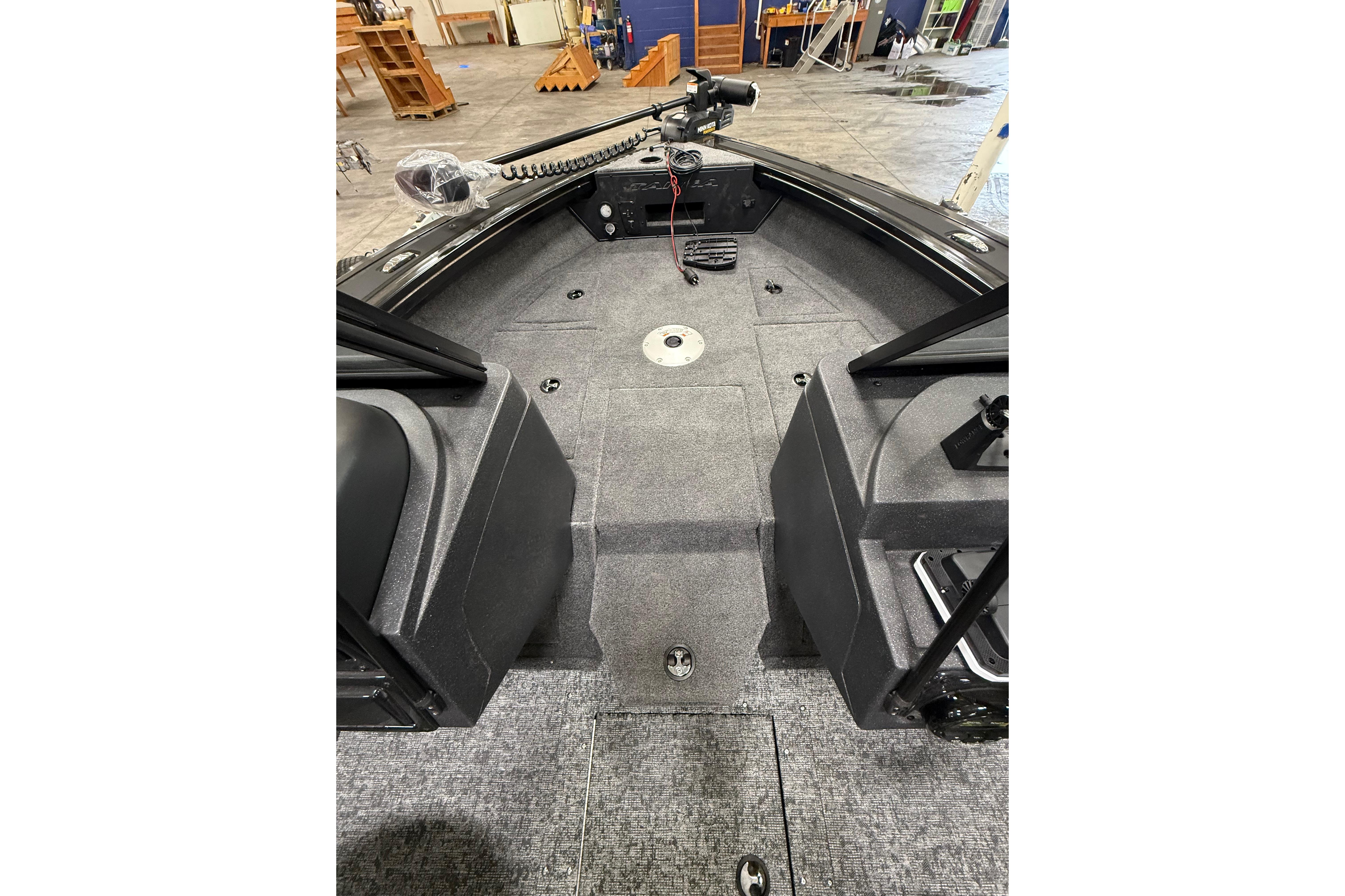 2026 Tracker Targa V-19 WT boat interior with carpeted deck and control panel.