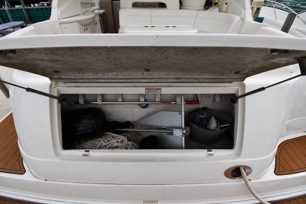 Open storage compartment on a 2003 Sea Ray 460 Sundancer yacht, showing ropes and equipment.