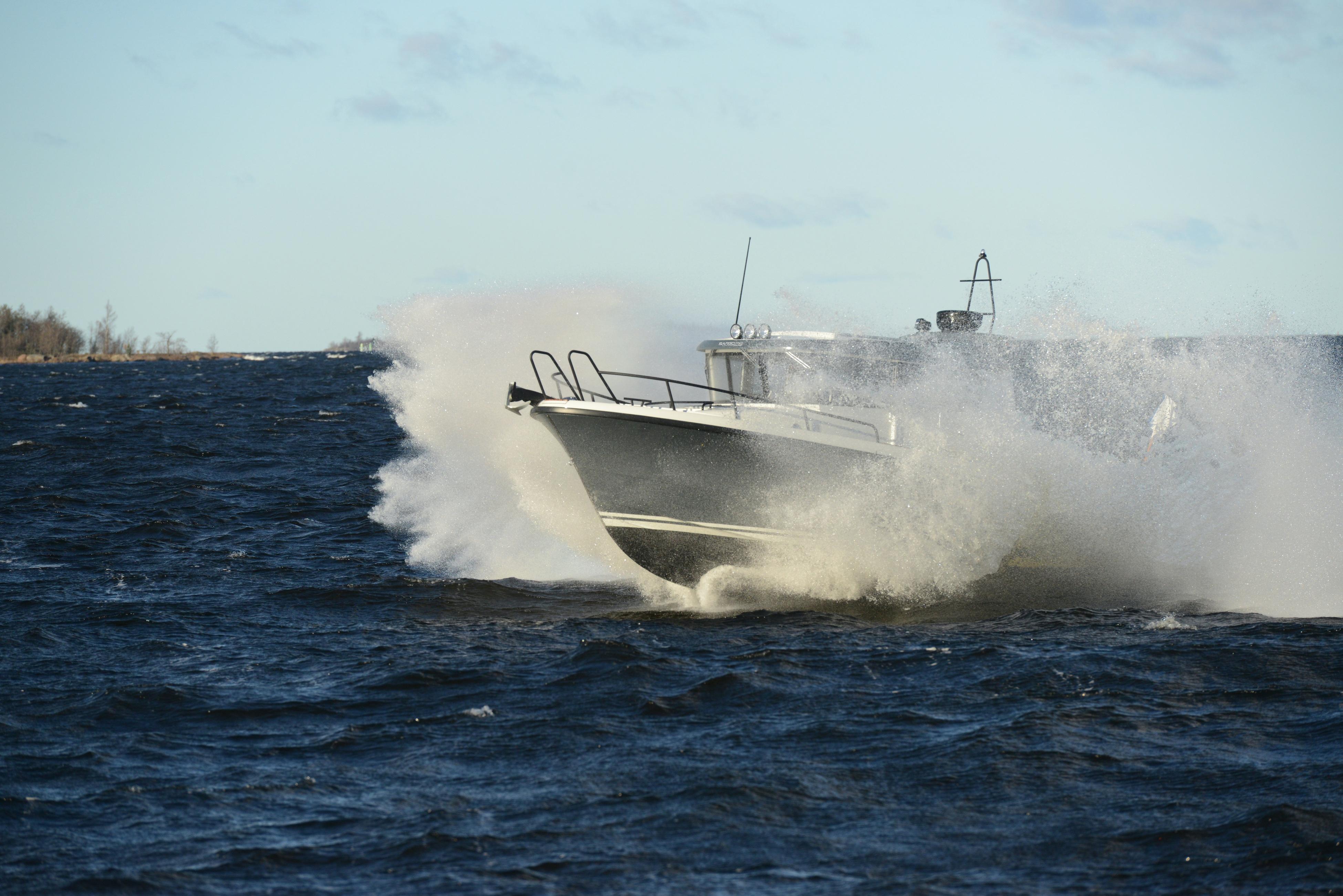 2024 Sargo 28 boat navigating rough waters with splashing waves.