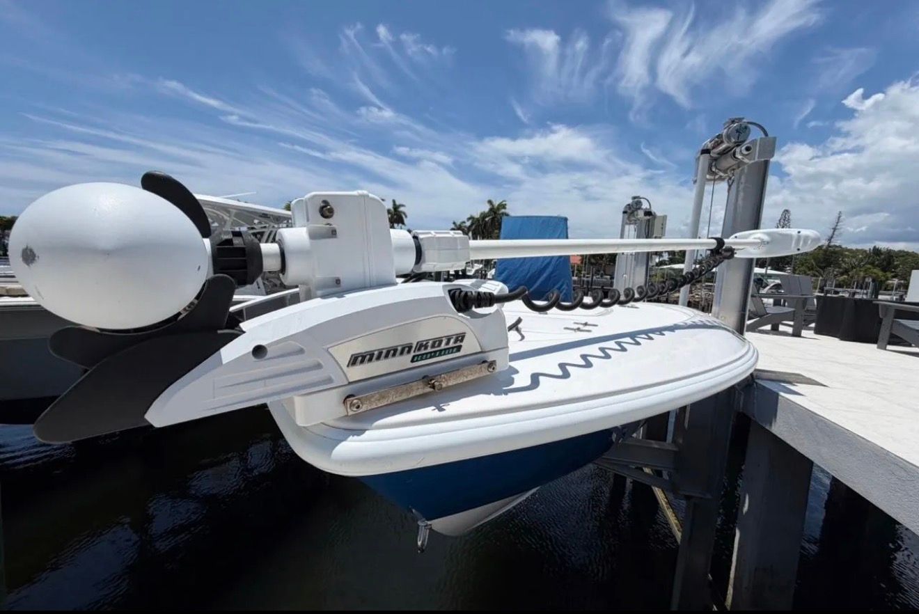 A 2016 Contender 25 Bay boat is on a boat lift above the water.
