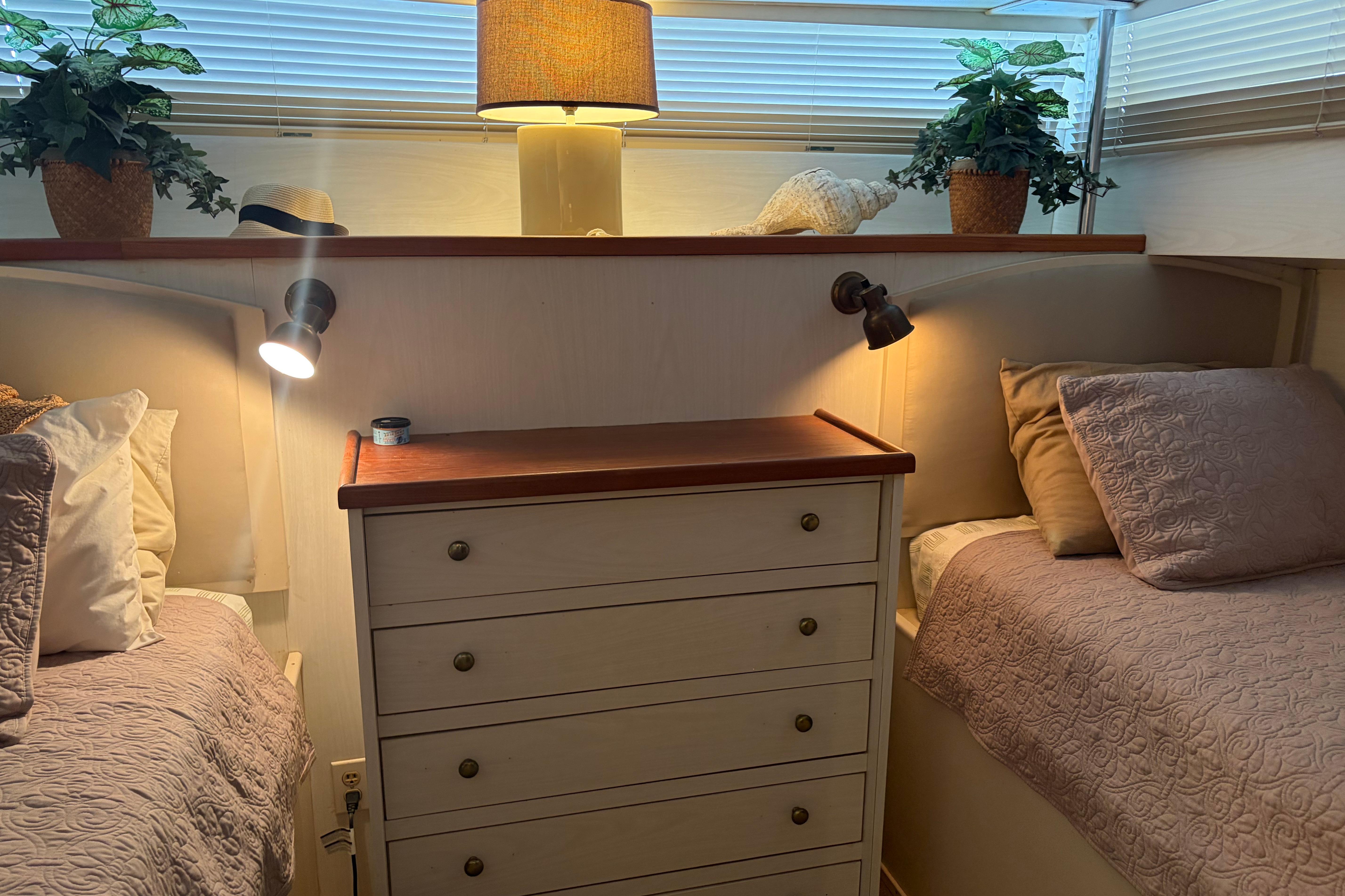 Cozy cabin interior of 1971 Chris-Craft 42 Commander with twin beds and warm lighting.
