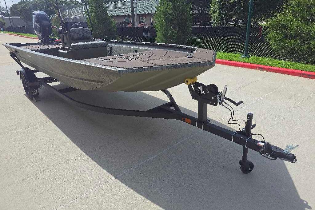 2026 Tracker Grizzly 1860 CC boat on trailer, parked outdoors.