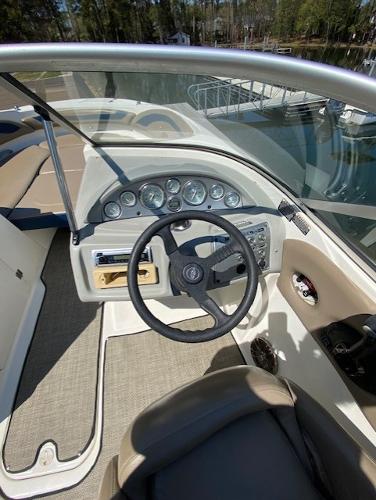 2005 Bayliner 249 SD boat dashboard with steering wheel and instrument panel.