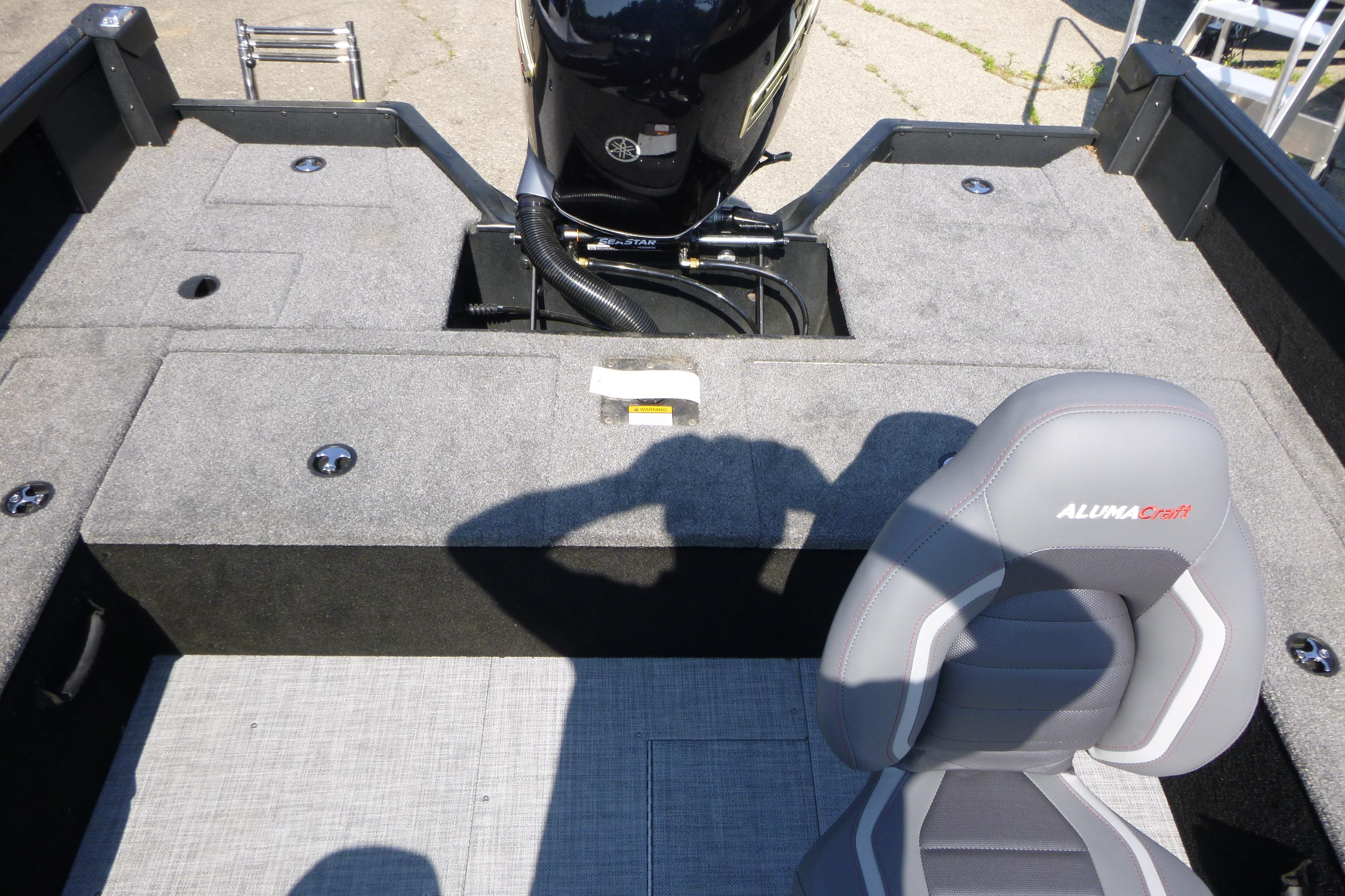 2024 Alumacraft Competitor 185X Sport boat interior with seating and motor view.