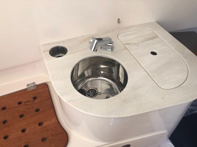 Grady-White Canyon 336 2021 boat kitchenette with stainless steel sink.