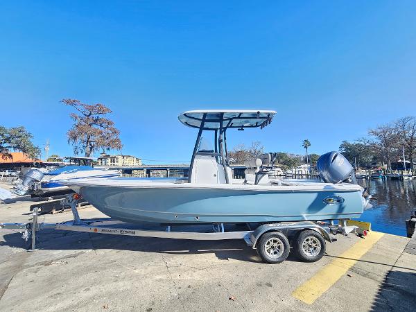 2026 Sea Hunt BX 22 BR boat on trailer by waterfront, clear blue sky.