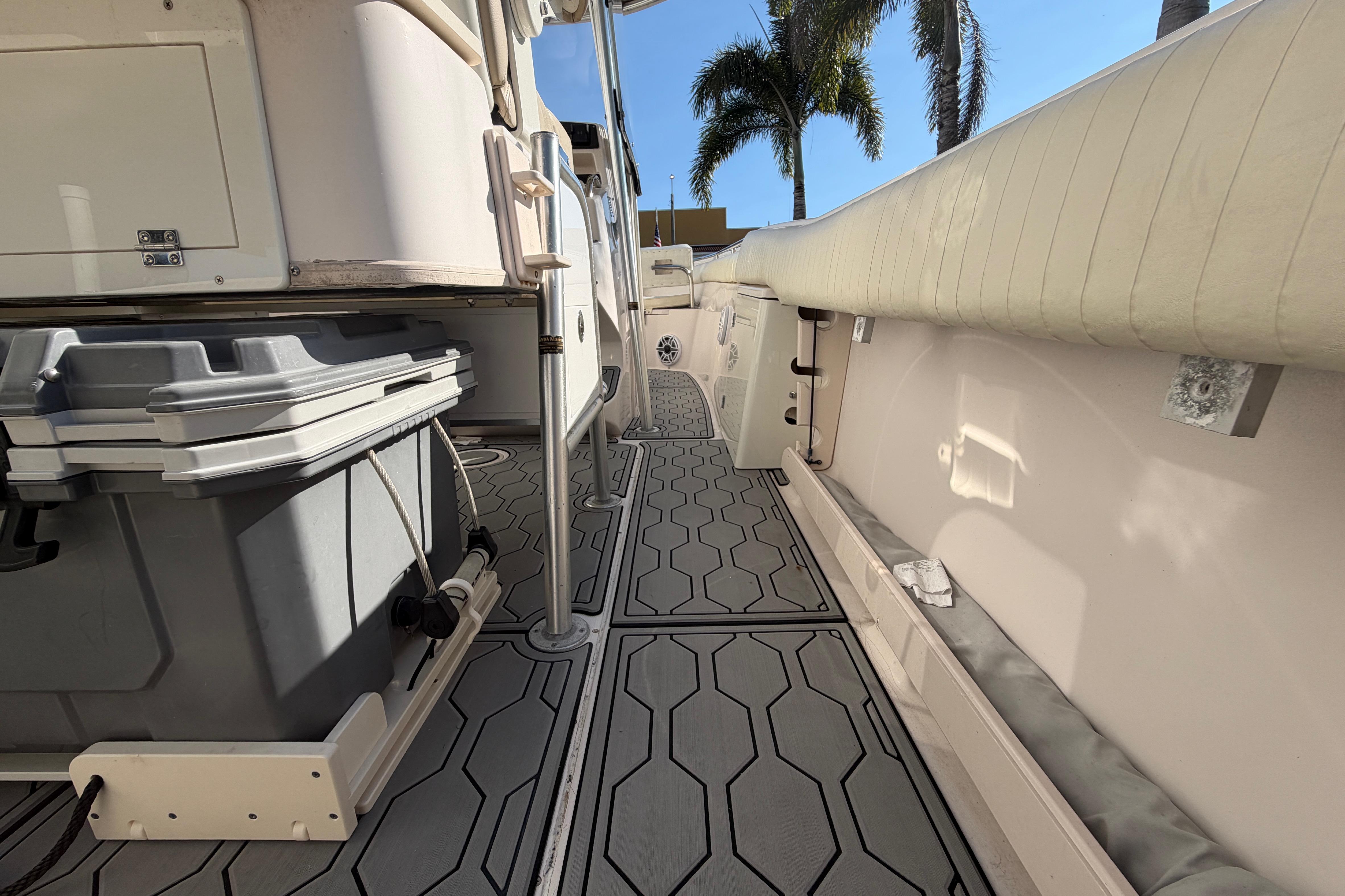 2004 Grady White 273 boat interior with storage and seating, featuring hexagonal flooring design.
