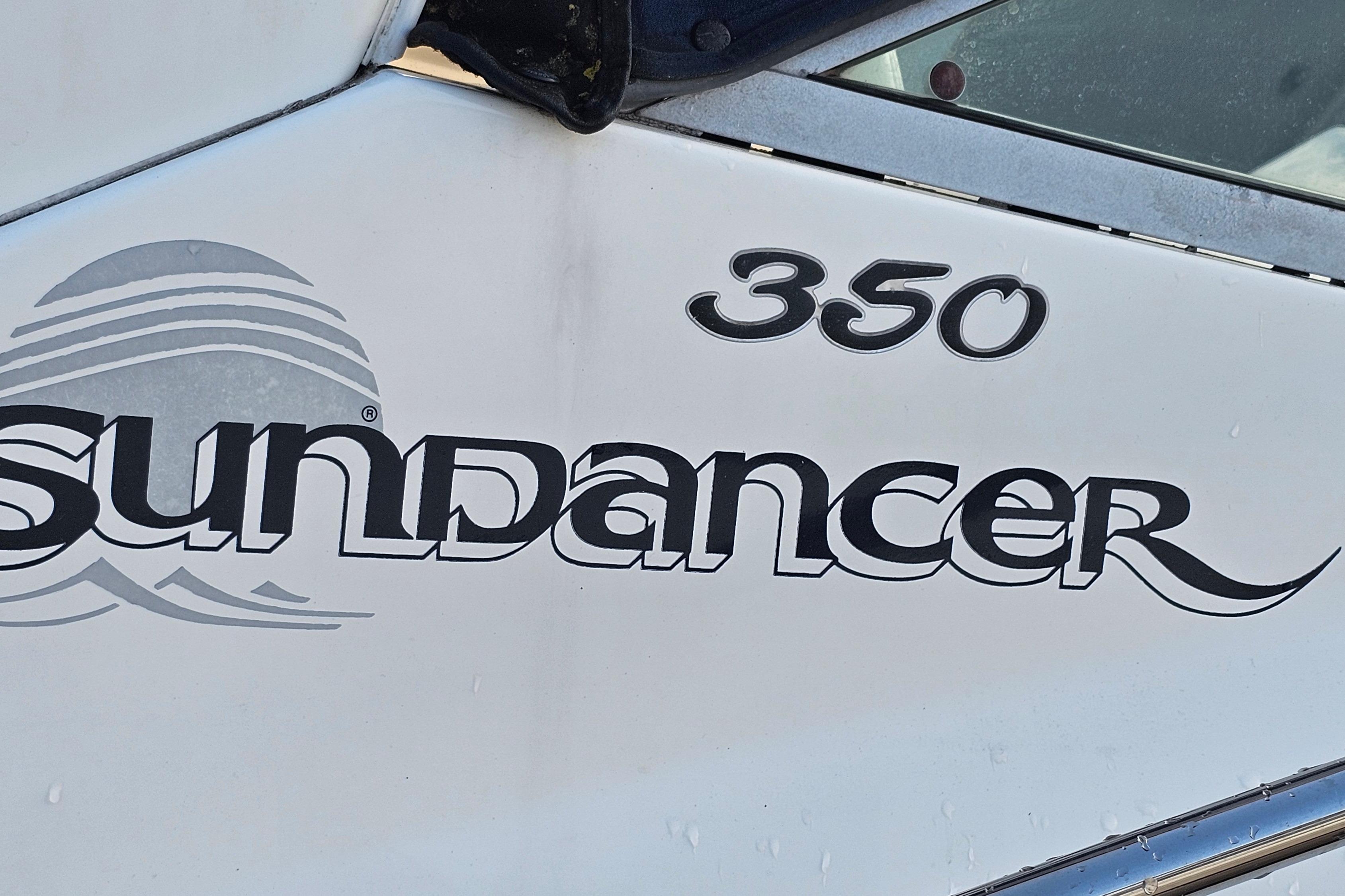 2008 Sea Ray Sundancer 350 boat logo and model number on white surface.