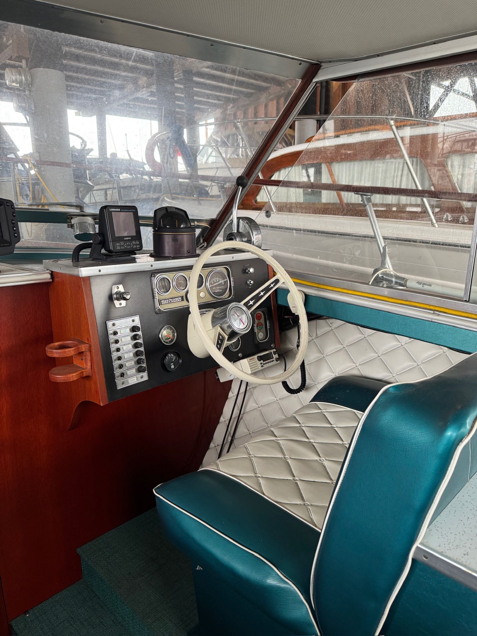 The image shows the cockpit of a 1972 Skiff Craft Hardtop with a white steering wheel and blue seats.