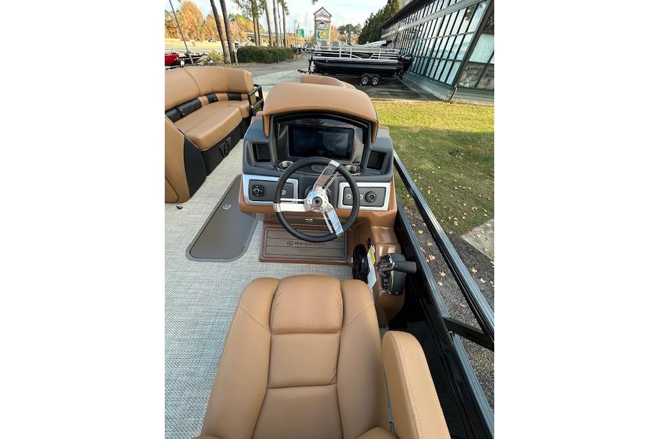 2025 Regency 230 LE3 Sport boat interior with tan seating and modern dashboard.