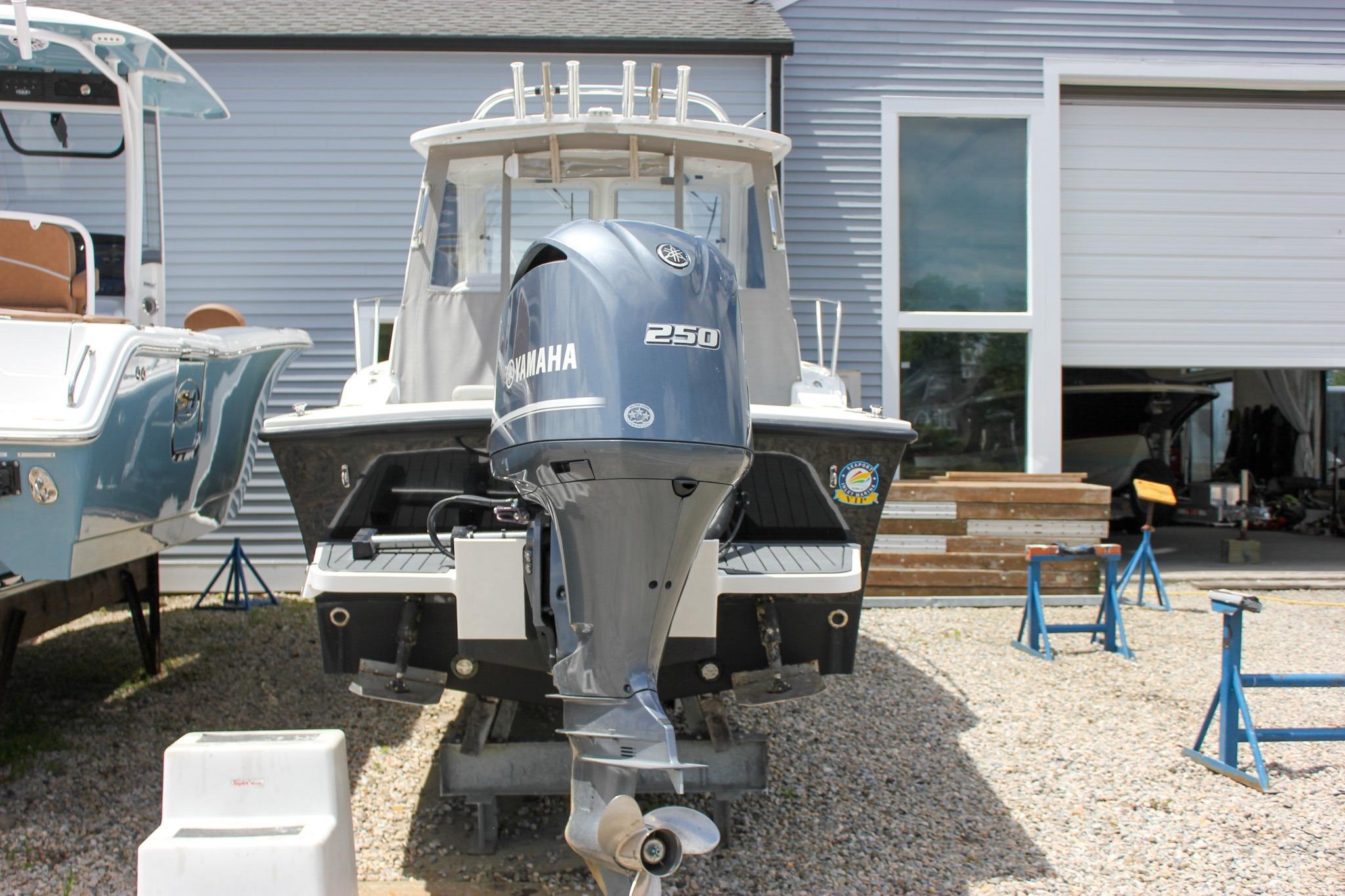 2022 NorthCoast 235 Cabin boat with Yamaha 250 engine, parked outdoors.