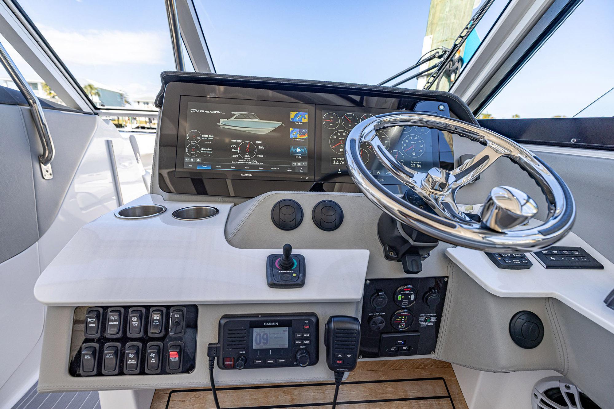 2022 Regal LX36 boat dashboard with steering wheel and digital display.