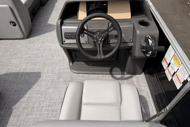 2026 Sun Tracker Party Barge 20 DLX helm with steering wheel and control panel.