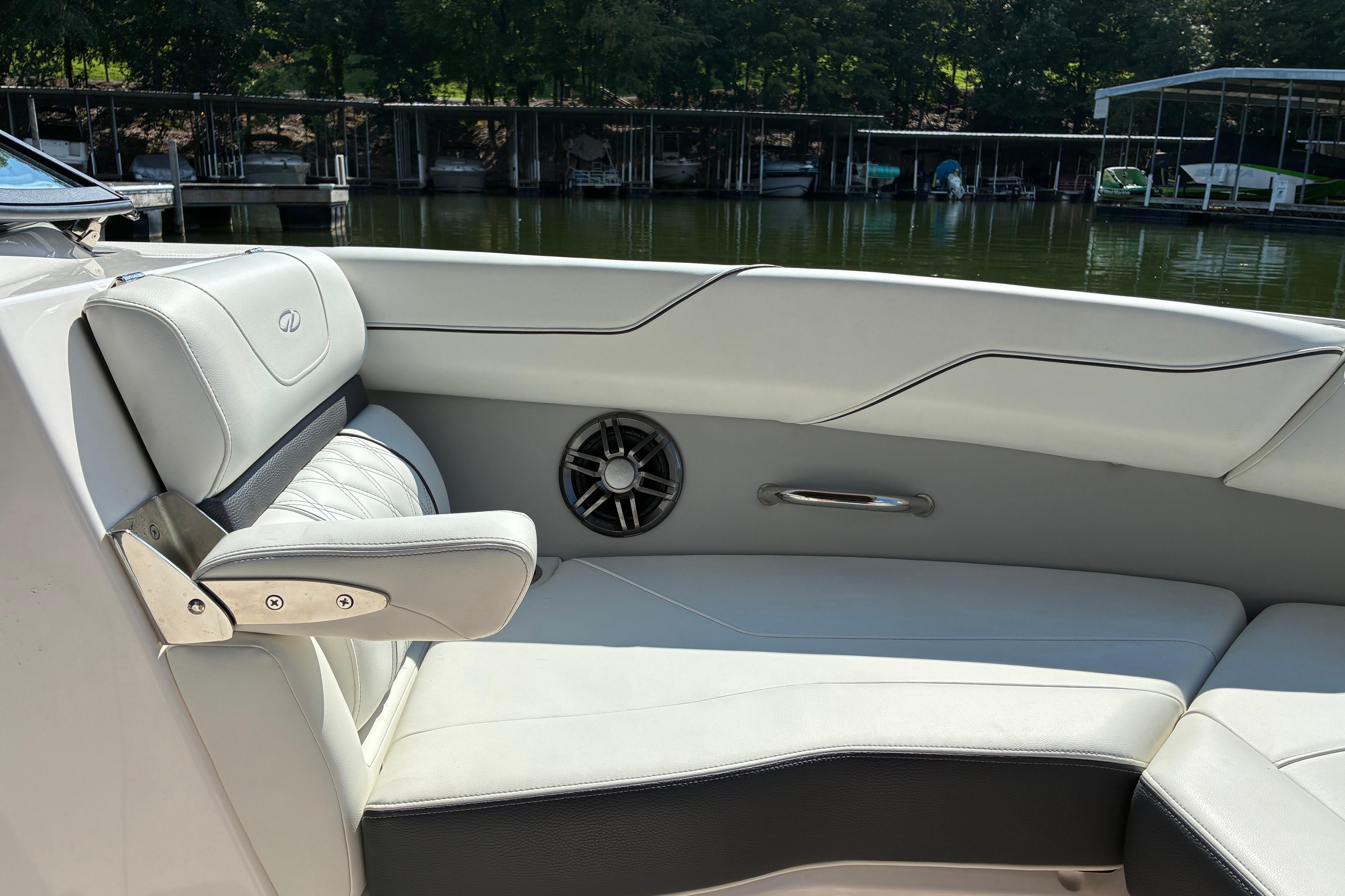 Luxurious interior of 2025 Regal LS2 boat with white leather seating and speaker.