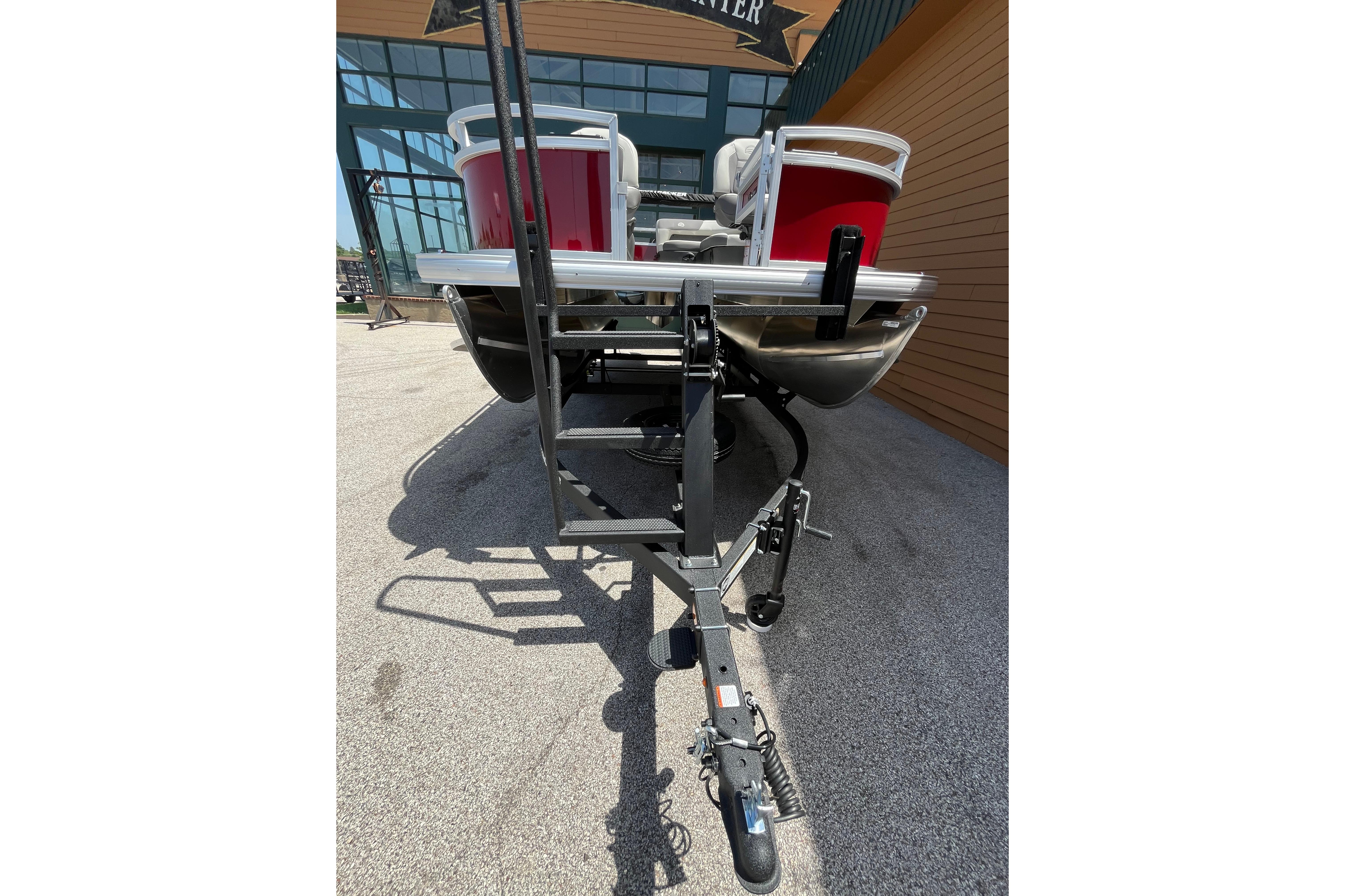 2026 Sun Tracker Bass Buggy 16 XL Select pontoon boat on trailer, rear view.