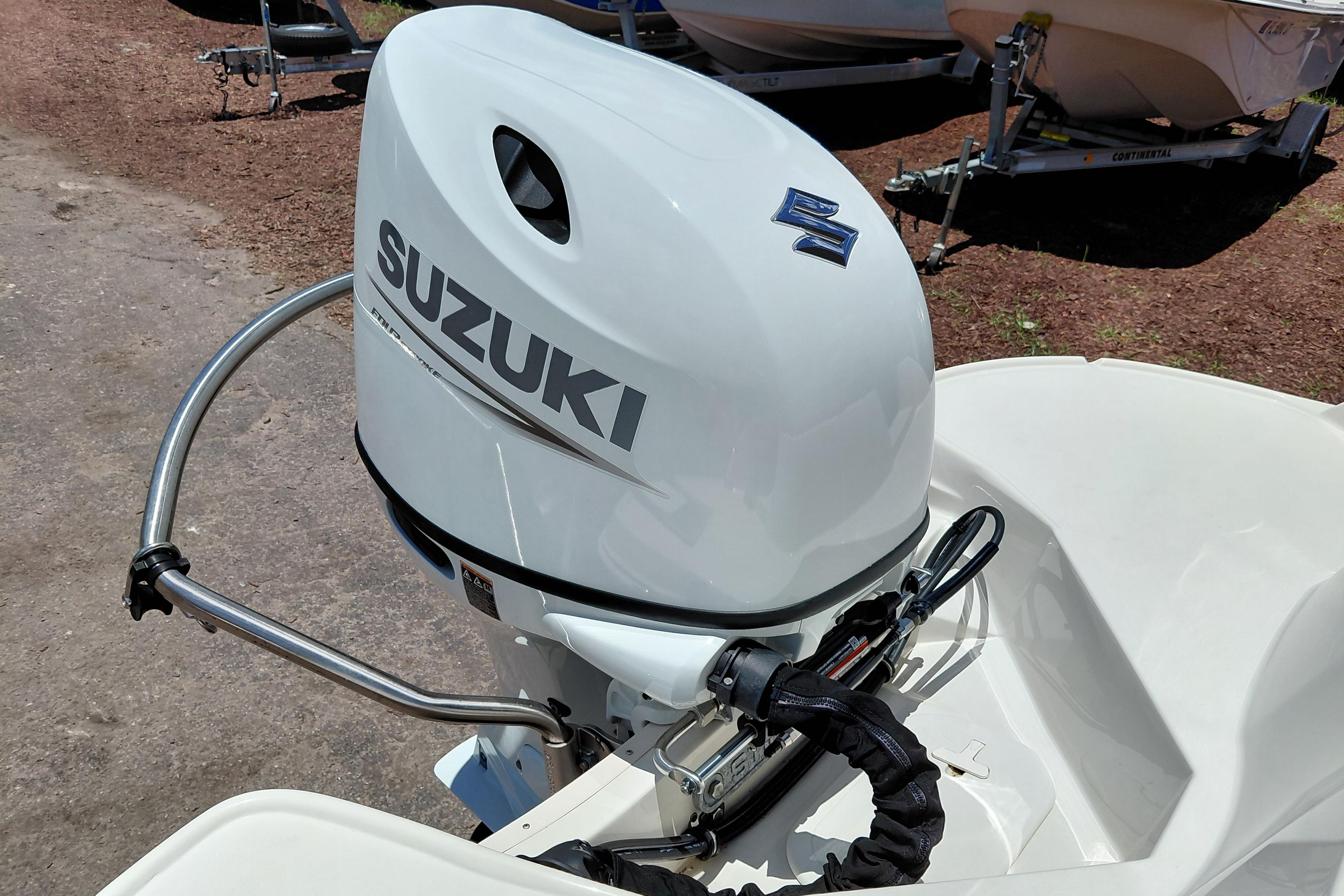2023 Stingray 206 CC boat with Suzuki outboard motor, parked on a trailer.