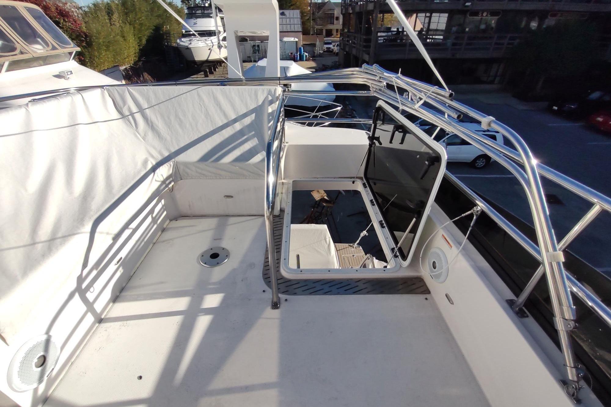 2021 Regal 42 Fly yacht deck with stainless steel railings and open hatch.