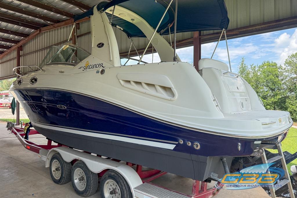 2006 Sea Ray Sundancer 260 boat on trailer in covered storage area.